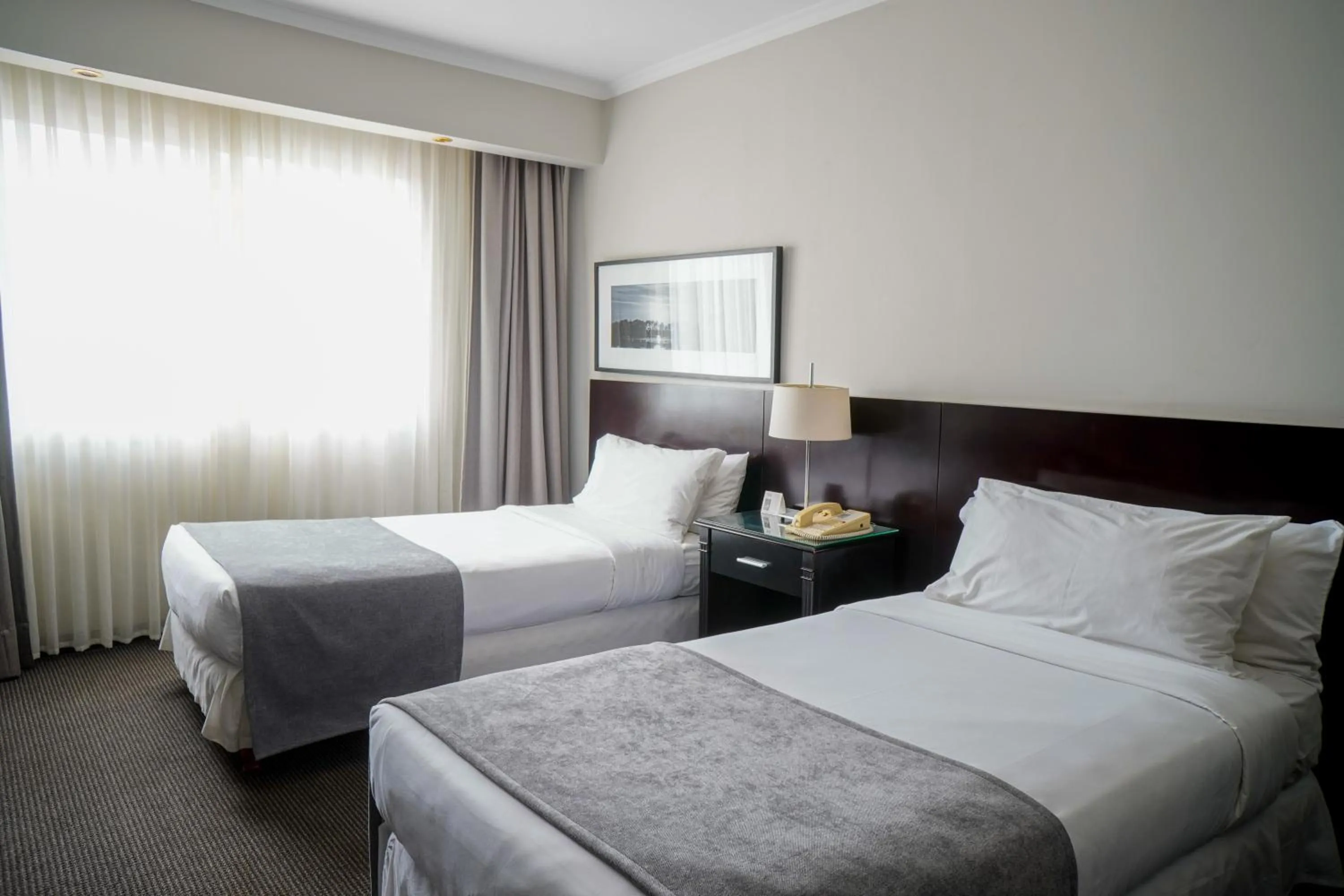 Bed in Plaza Real Suites Hotel