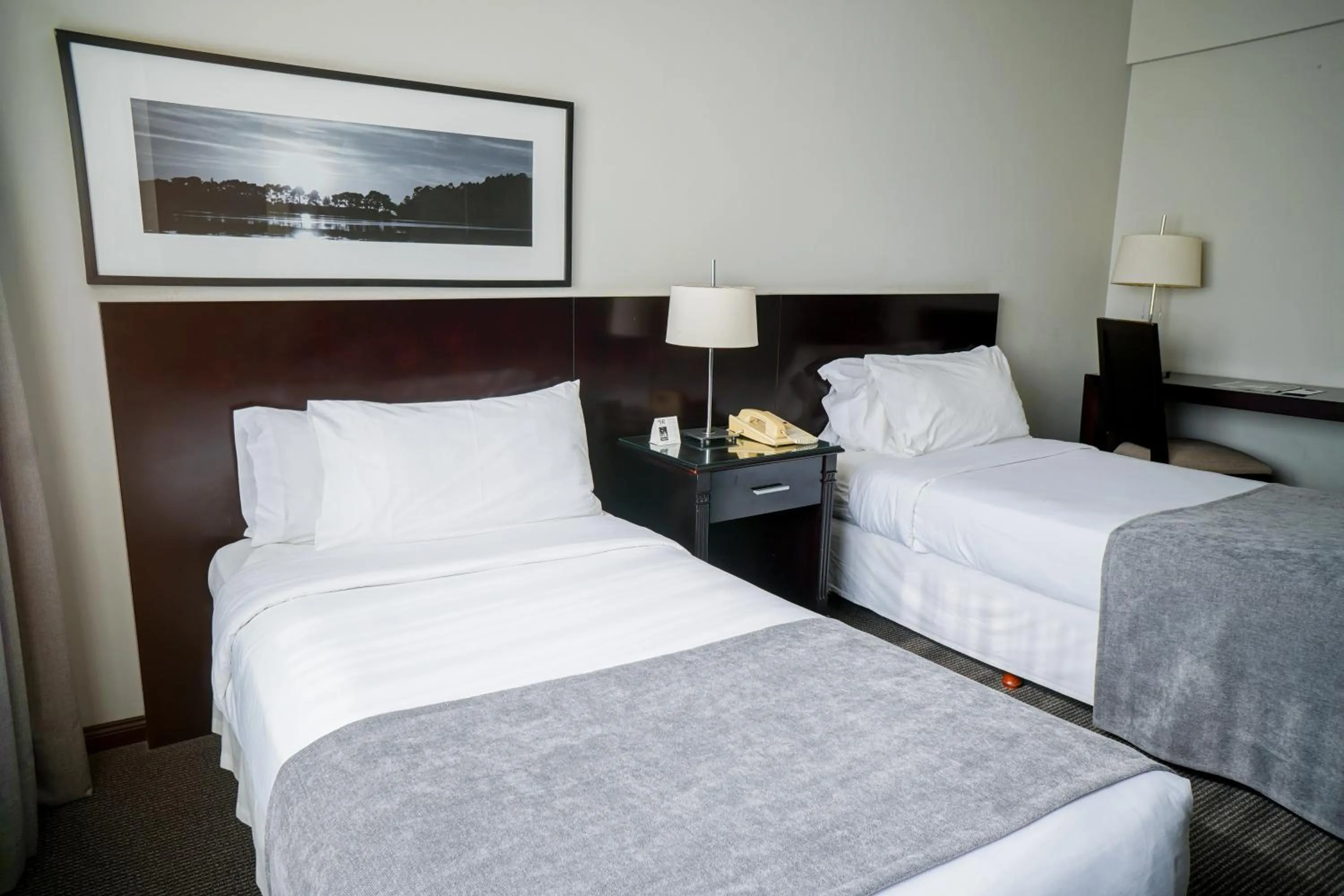 Bed in Plaza Real Suites Hotel