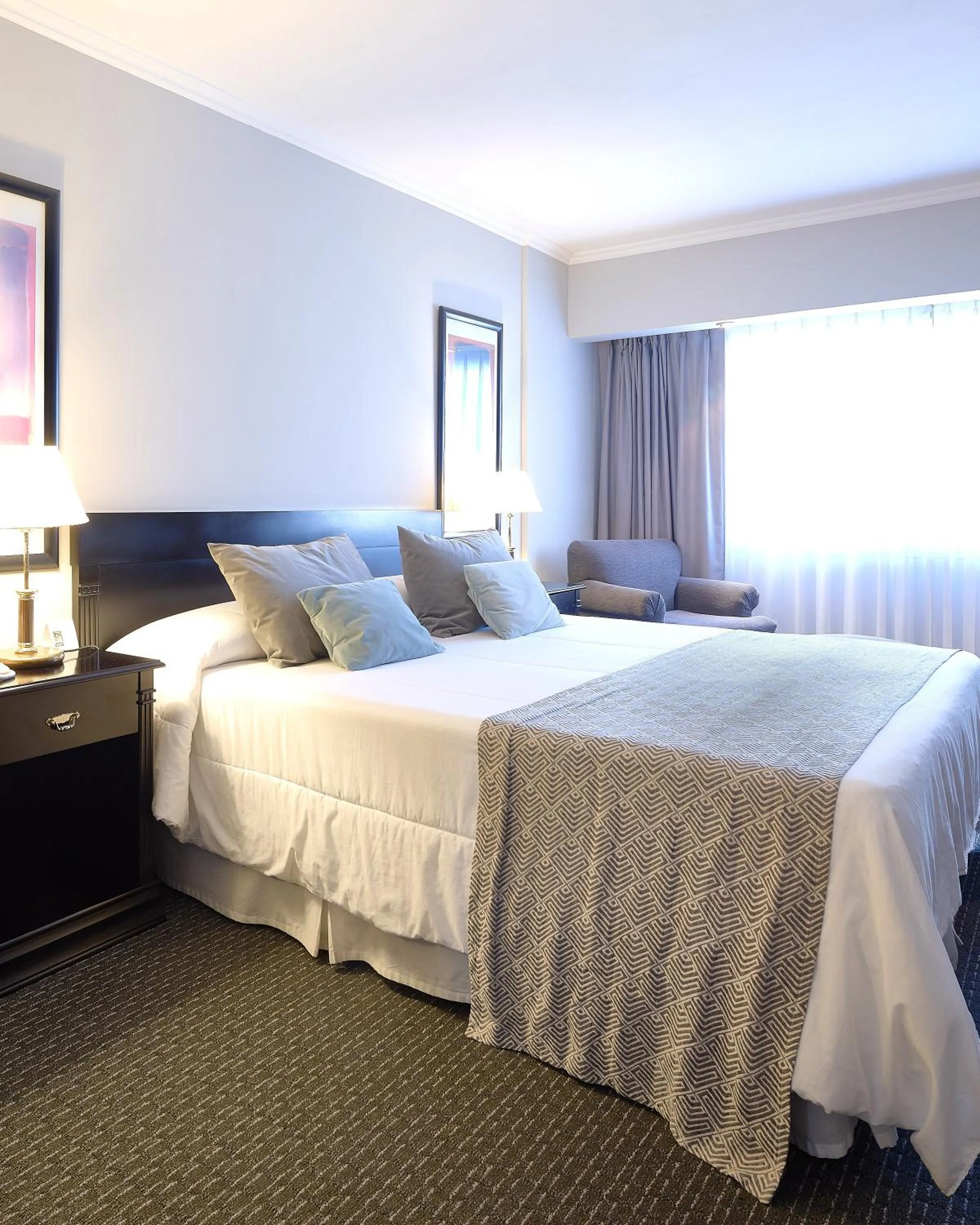 Bed in Plaza Real Suites Hotel