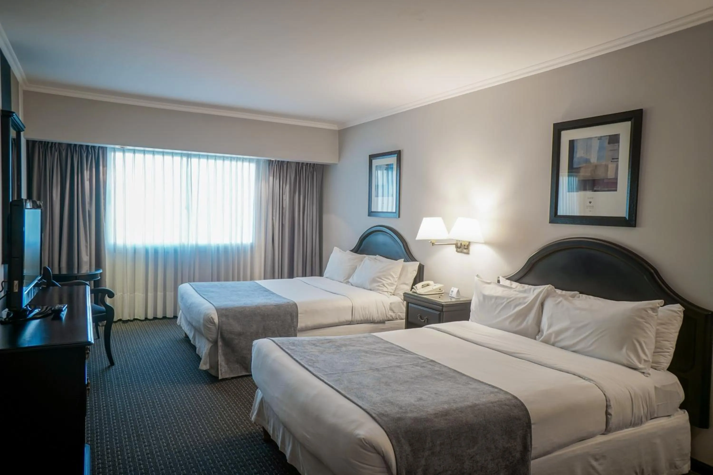 Bed in Plaza Real Suites Hotel