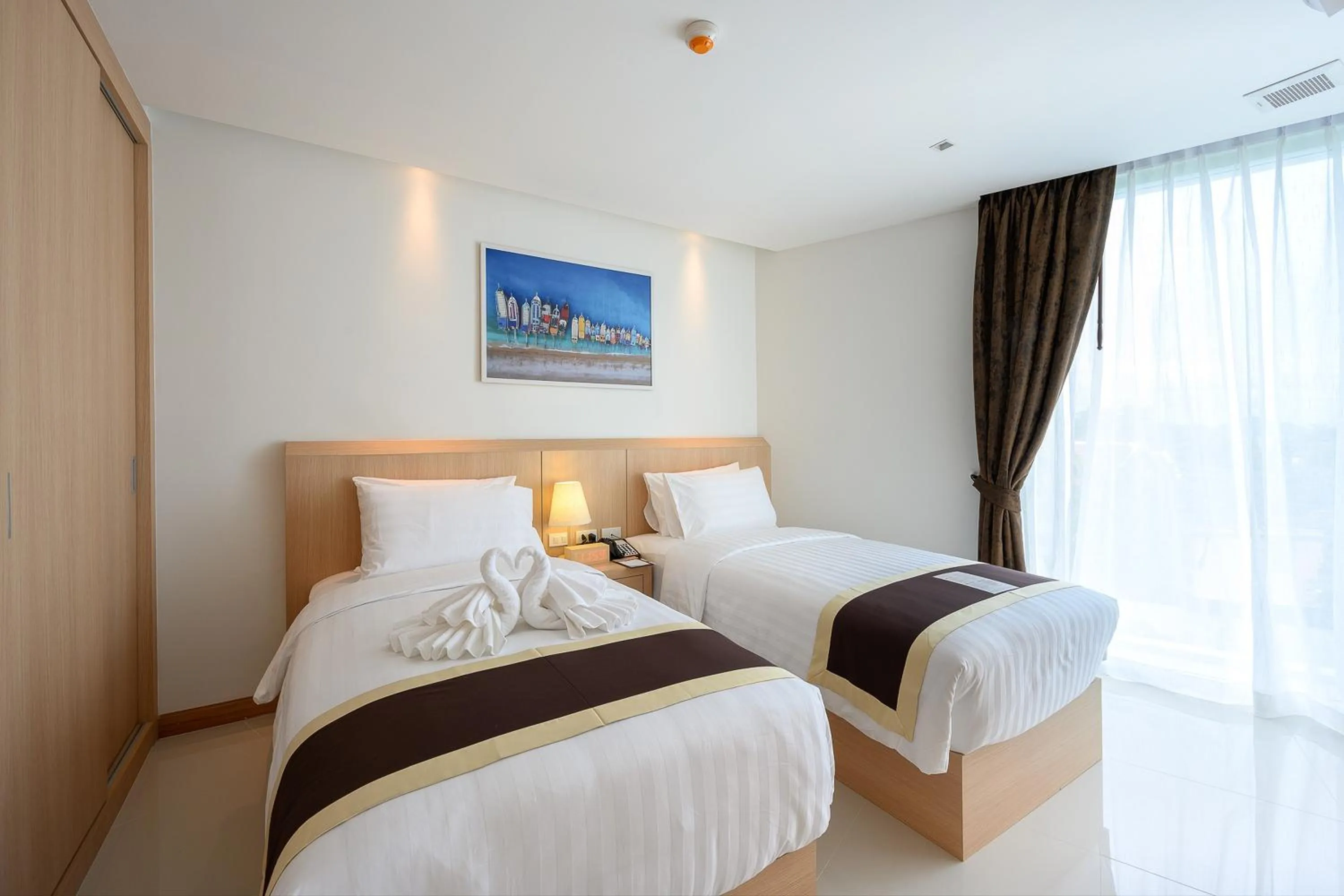 Bed in The Beachfront Hotel Phuket