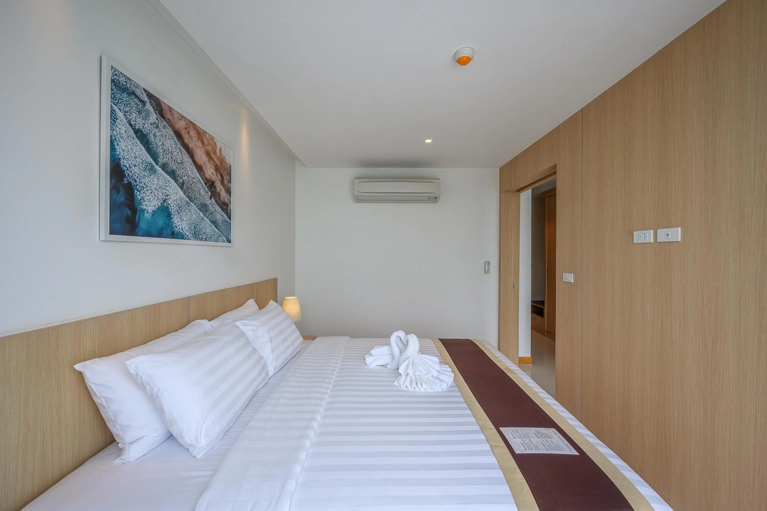 Bed in The Beachfront Hotel Phuket