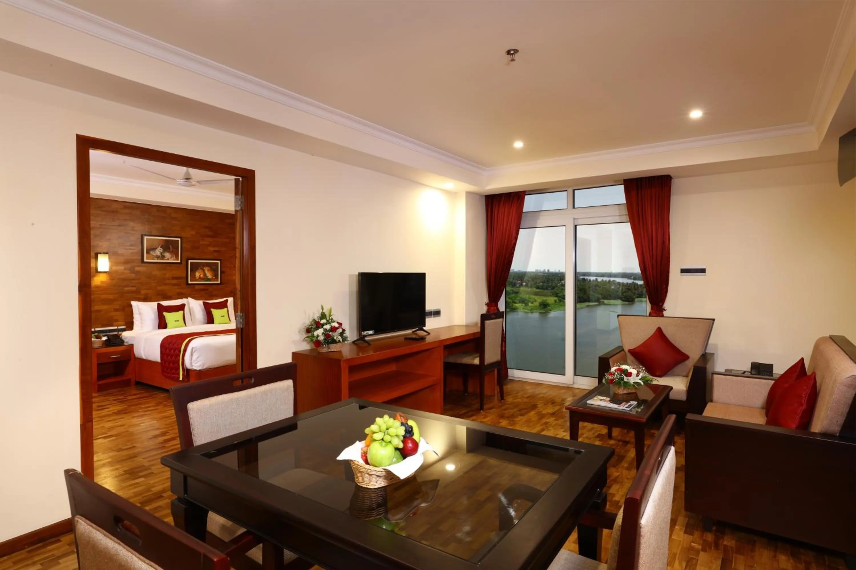 Living room, Bed in JVK Park Hotel