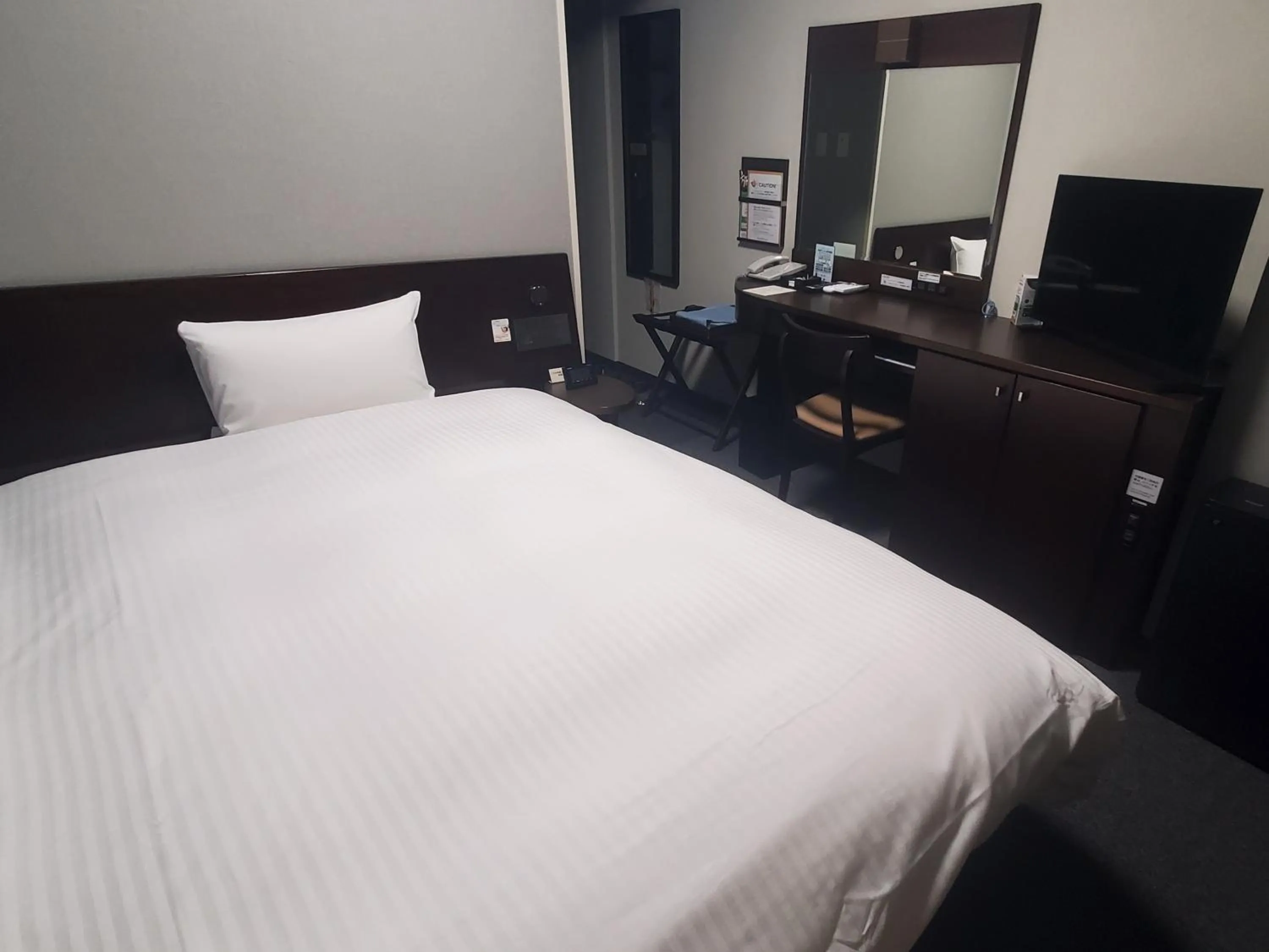 Photo of the whole room, Bed in Hotel Route-Inn Saga Ekimae
