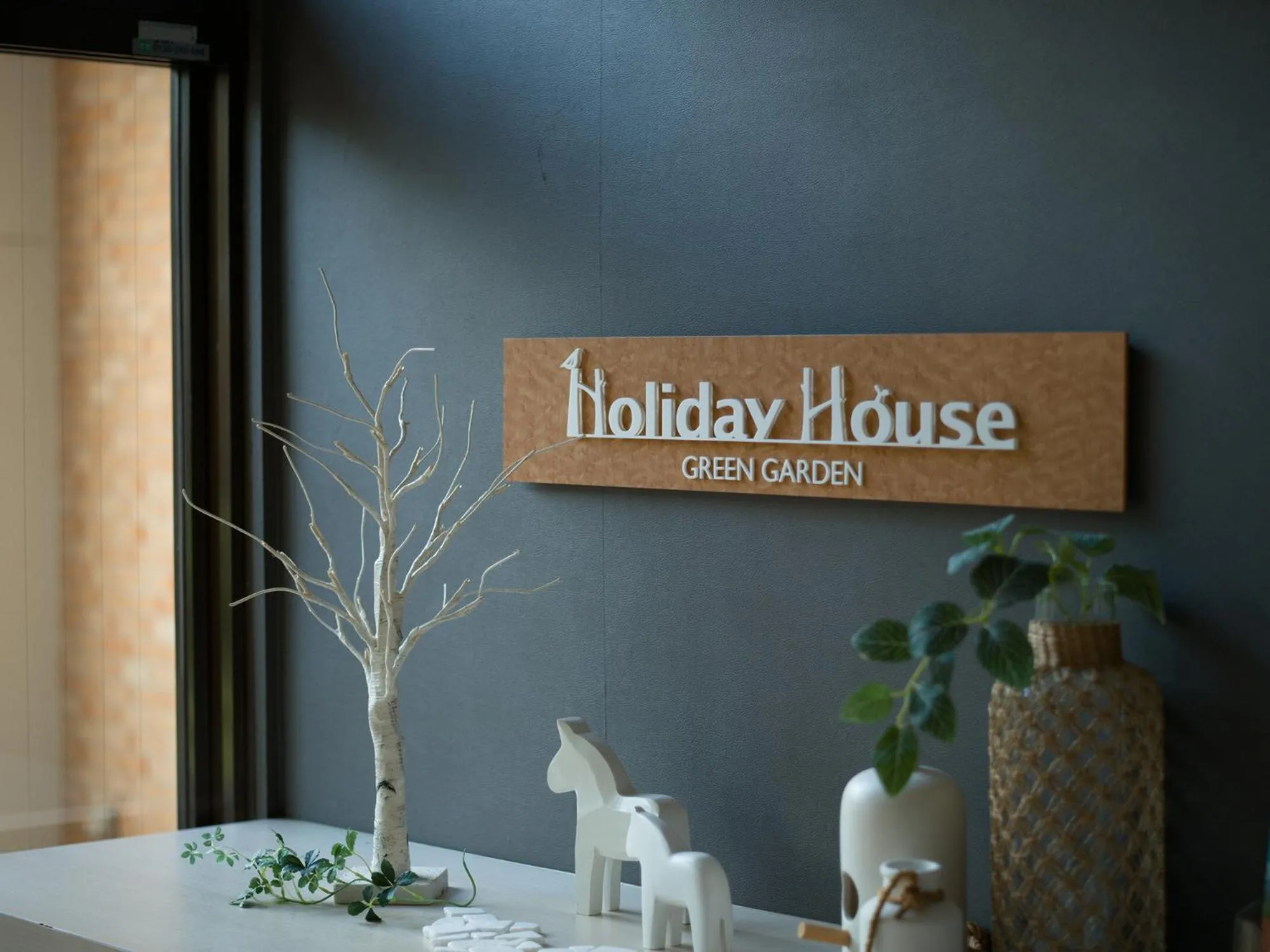 Property logo or sign in Holiday House Green Garden