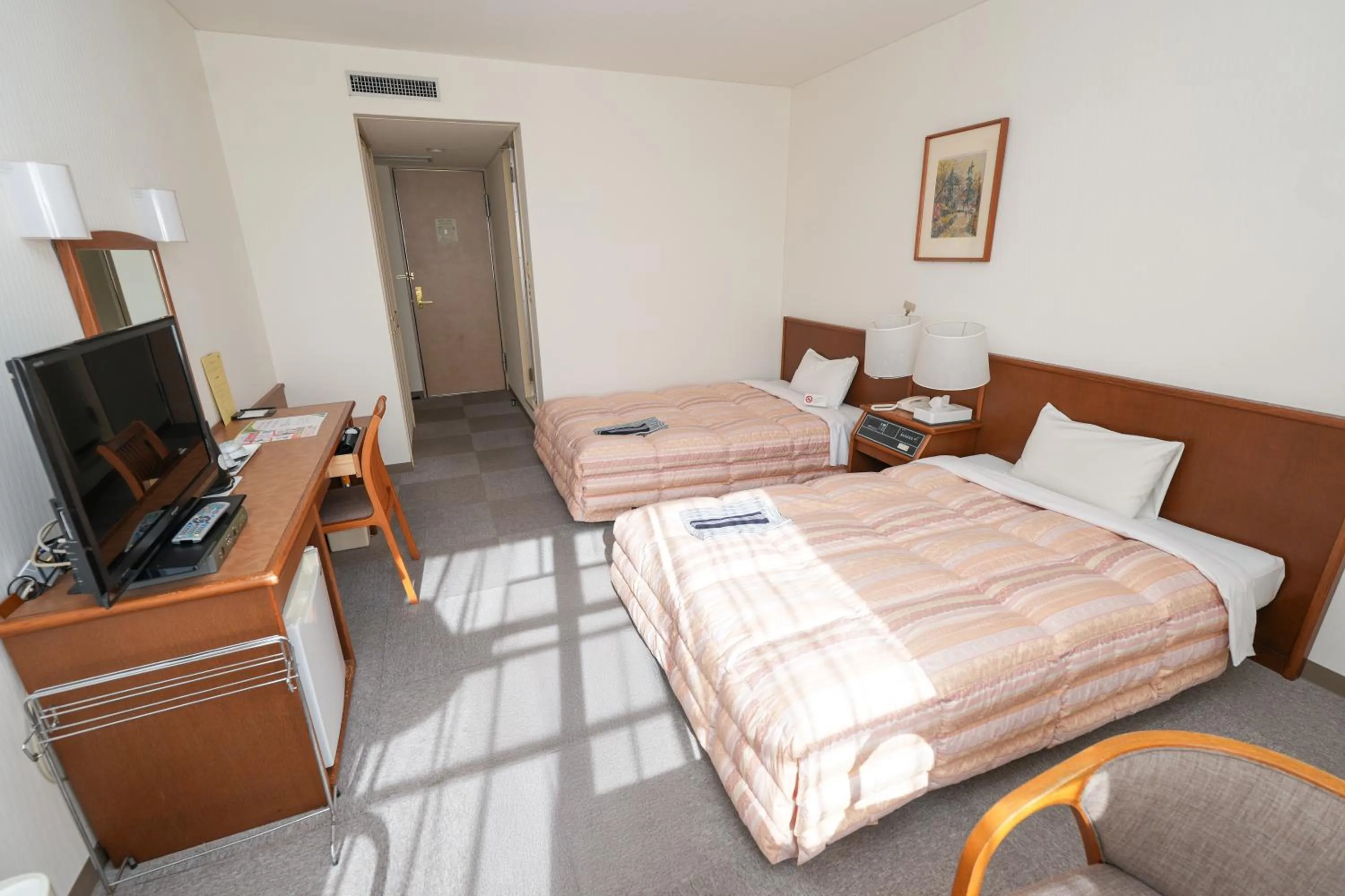 Bed in Tendo Central Hotel