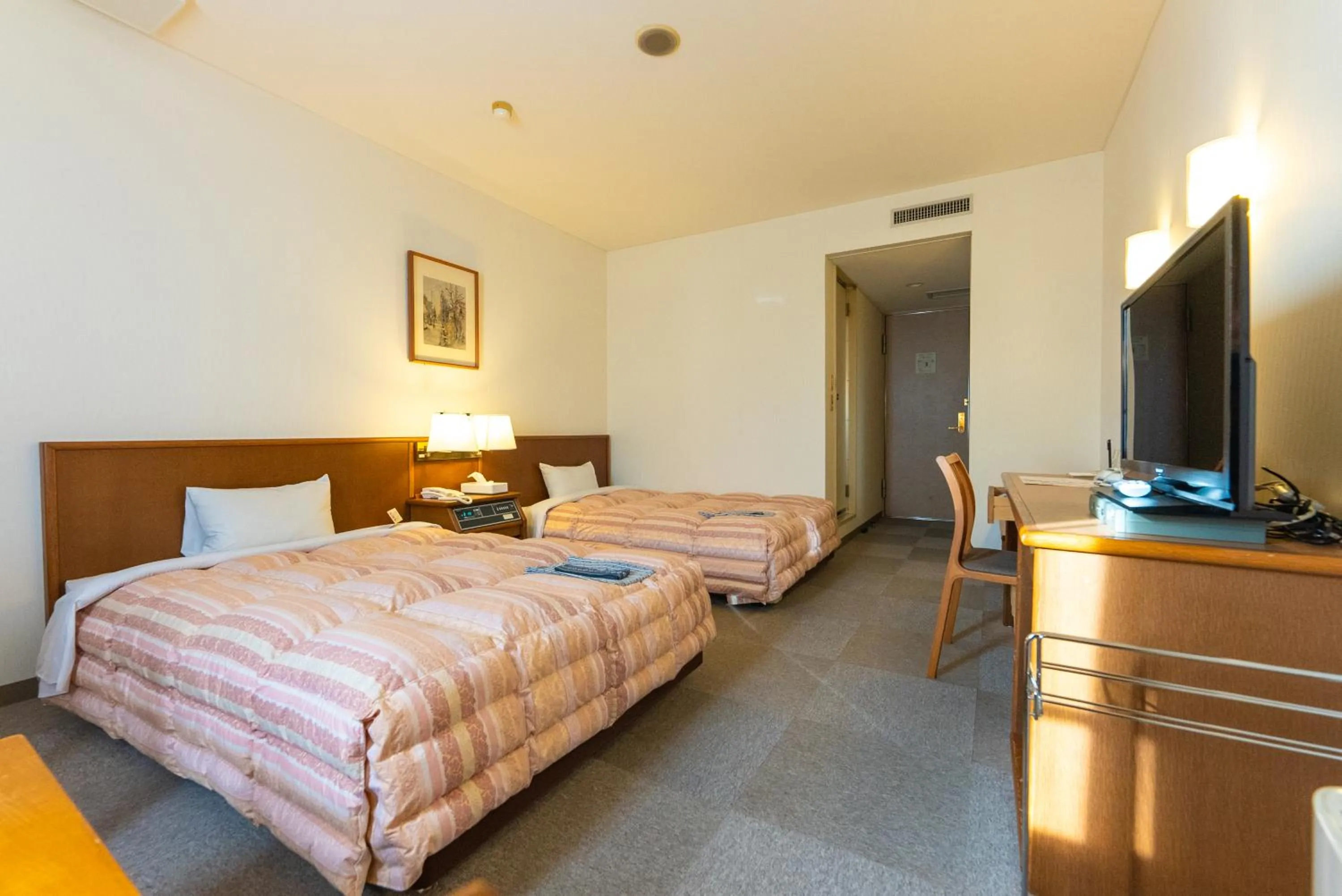 Bed in Tendo Central Hotel