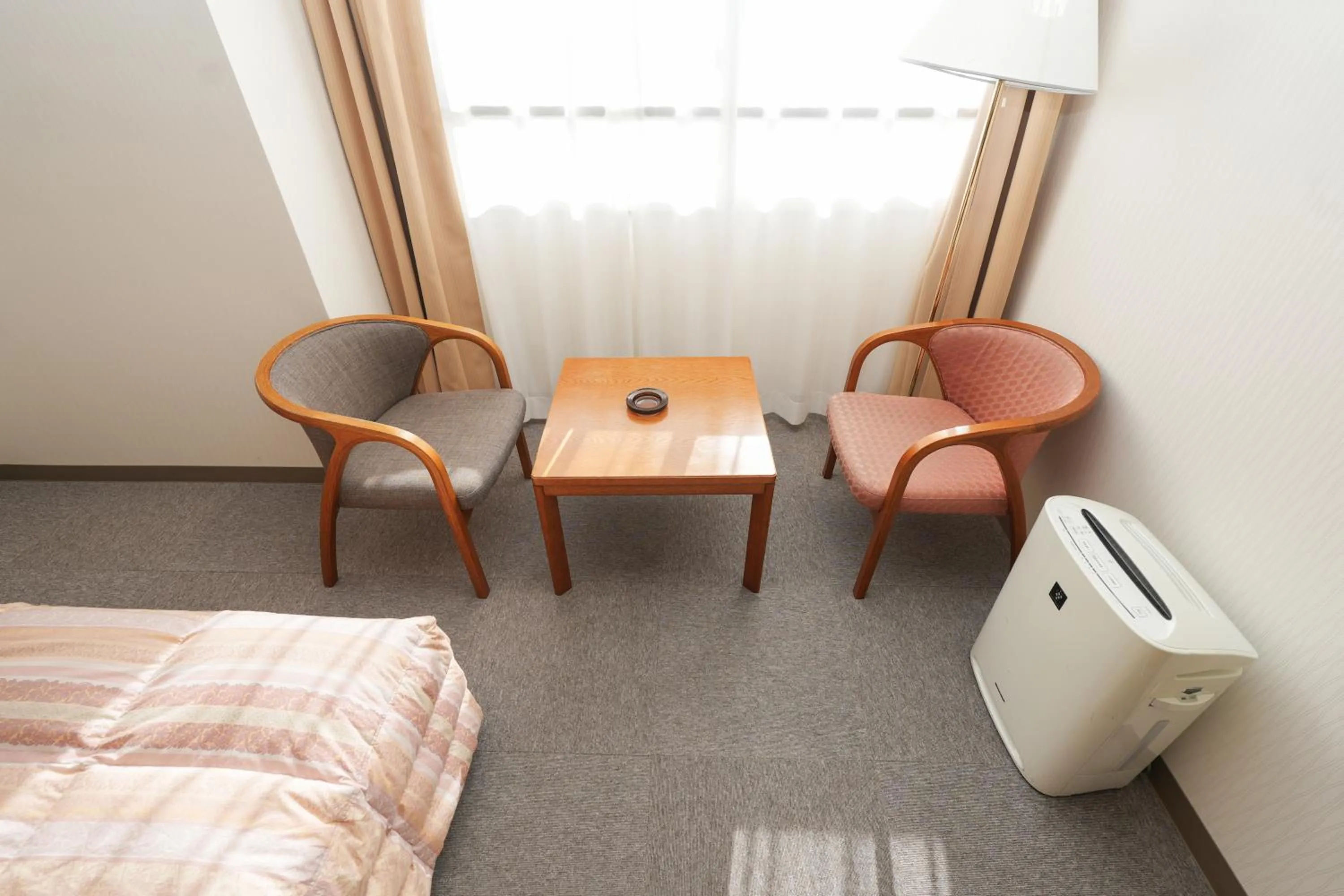 Bed in Tendo Central Hotel