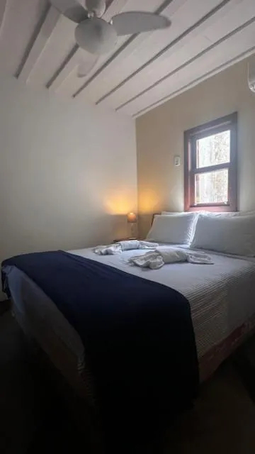 Bed in Pousada Casa das Rosas