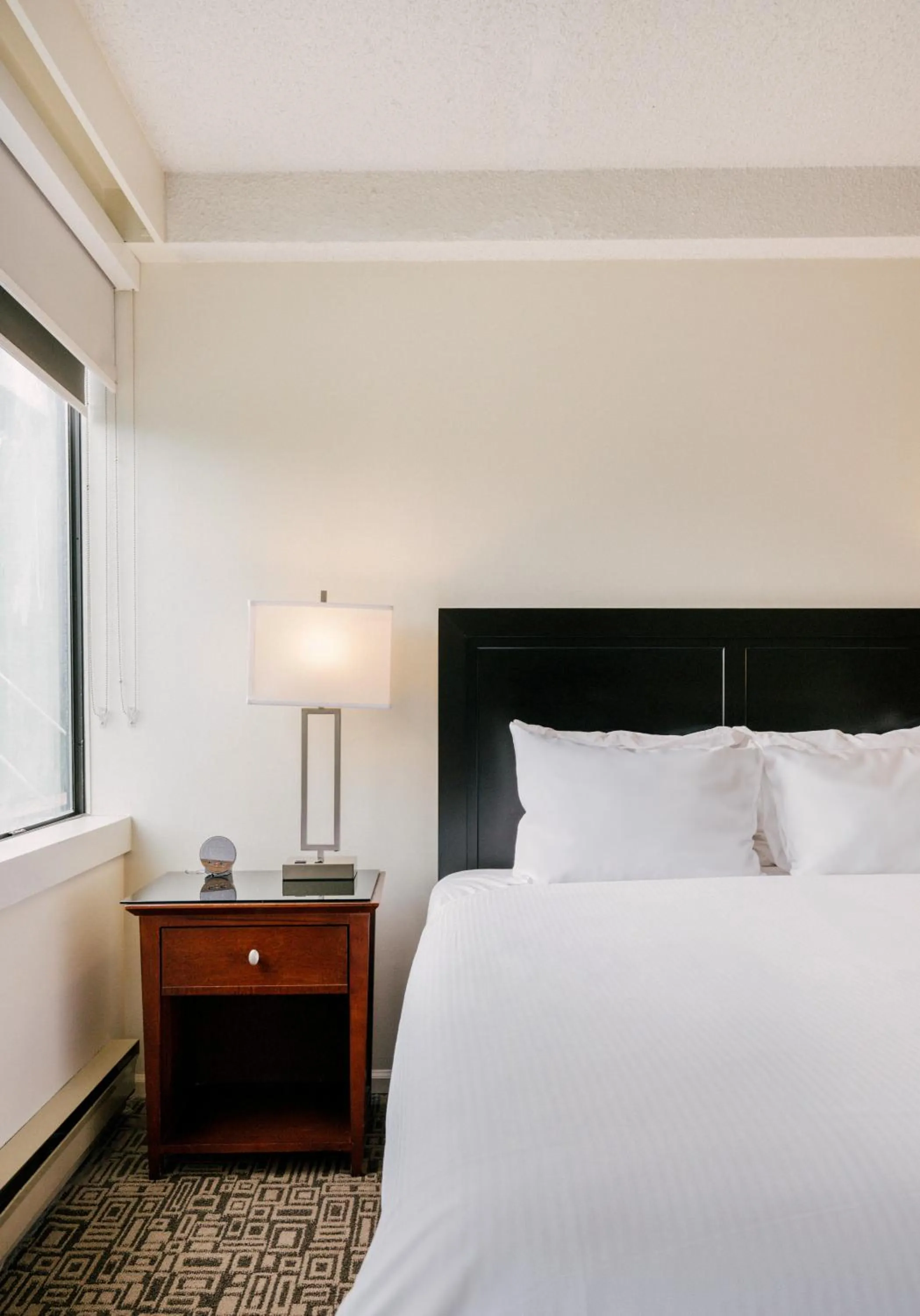 Bed in Mountain Side Hotel Whistler by Executive