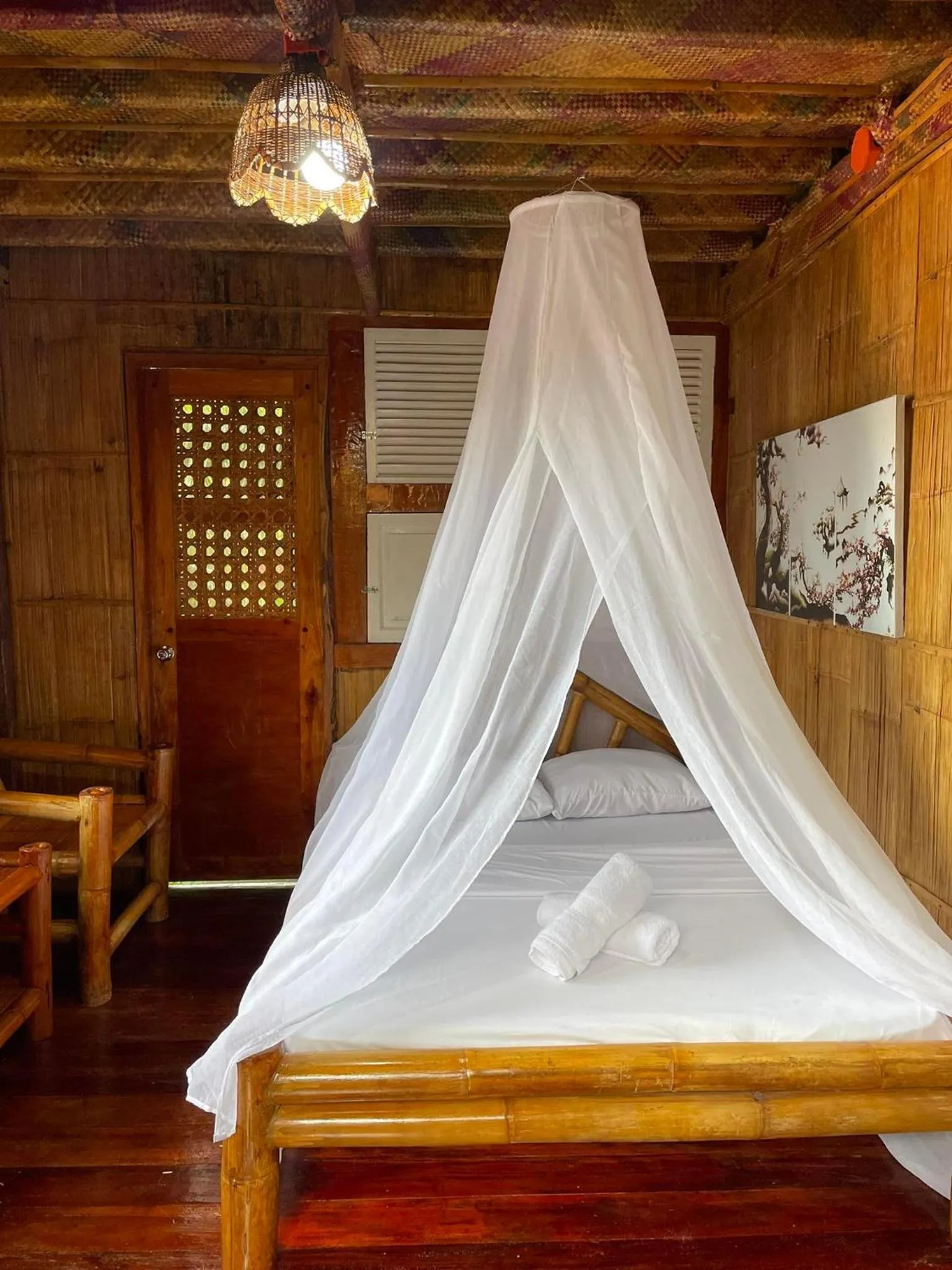 Bed in Camiguin Blue Lagoon Cottages