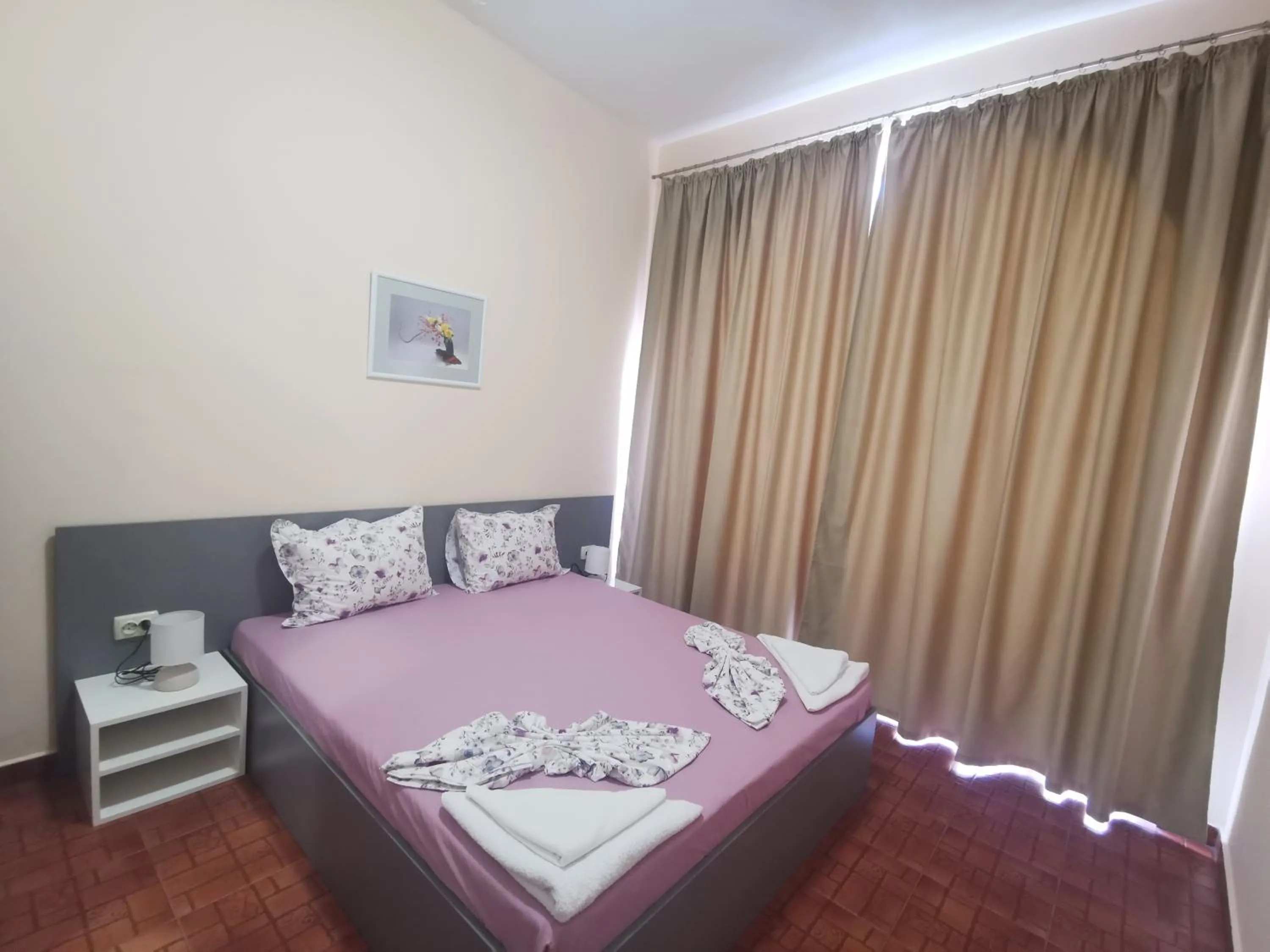 Bed in Rose Garden Omax Apartments