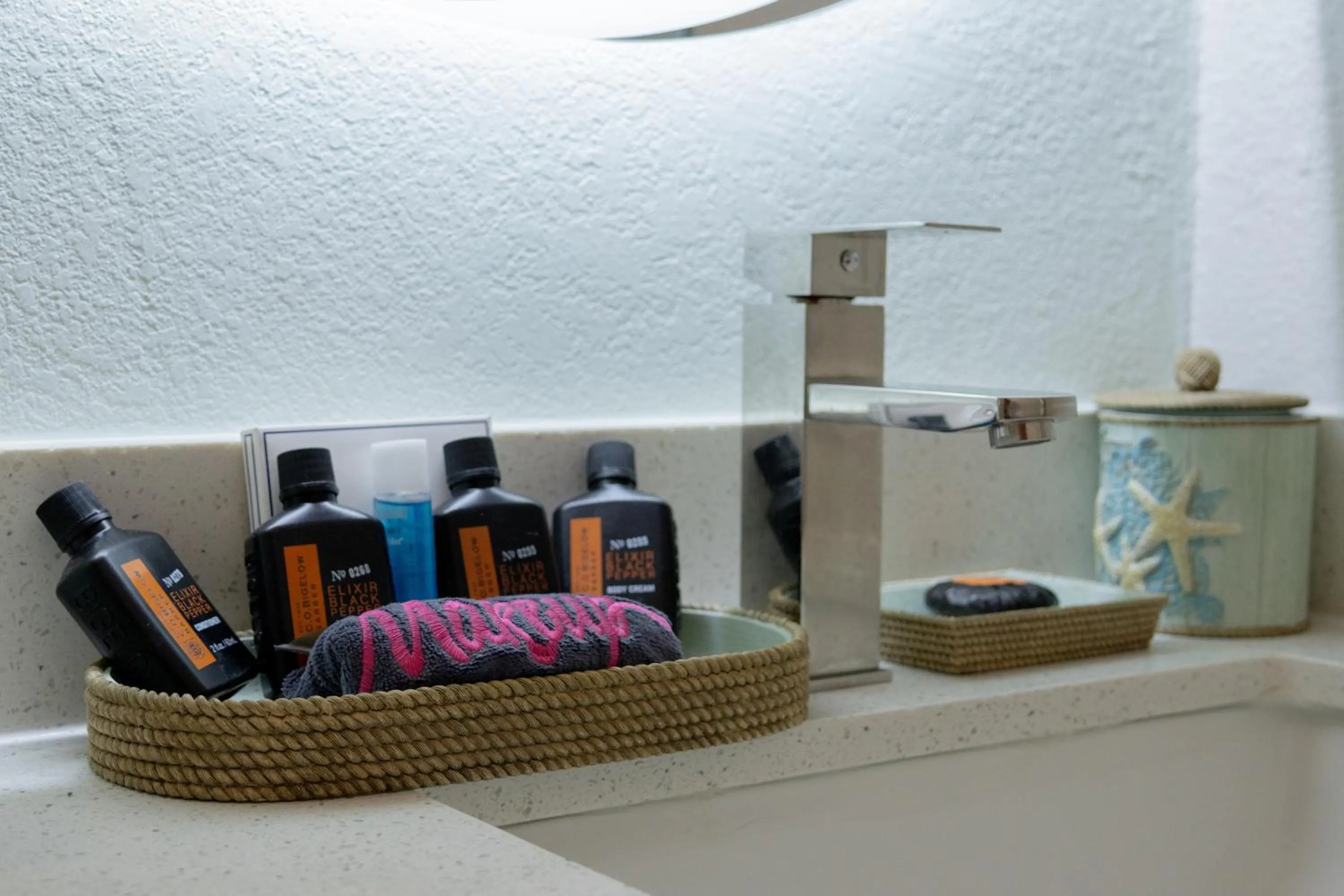 Bathroom in NEW 2026-Ocean Sands Beach Boutique Inn-Sauna and Salt-Mineral Pool -Free Beach Bikes and Famous Beach- Fresh Baked Cookies and Popcorn - Bathrobes and Sunscreen in all rooms-Ultra Sparkling-Free Laundry- 4 Grand Black Beds-Call NOW & Save-1-252-AHA-SAND