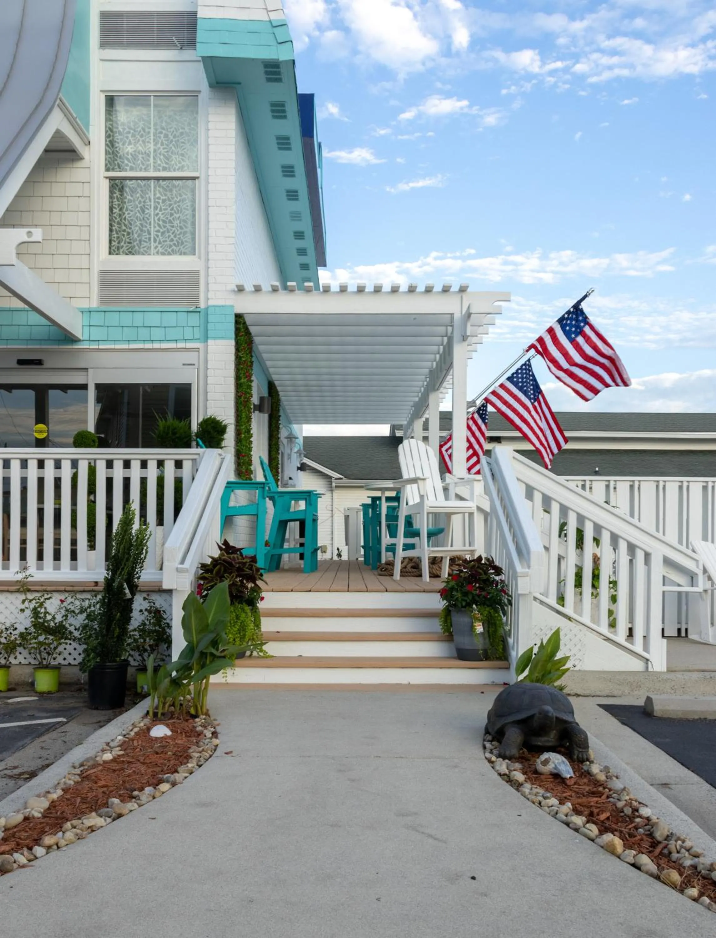 Property building in NEW 2026-Ocean Sands Beach Boutique Inn-Sauna and Salt-Mineral Pool -Free Beach Bikes and Famous Beach- Fresh Baked Cookies and Popcorn - Bathrobes and Sunscreen in all rooms-Ultra Sparkling-Free Laundry- 4 Grand Black Beds-Call NOW & Save-1-252-AHA-SAND