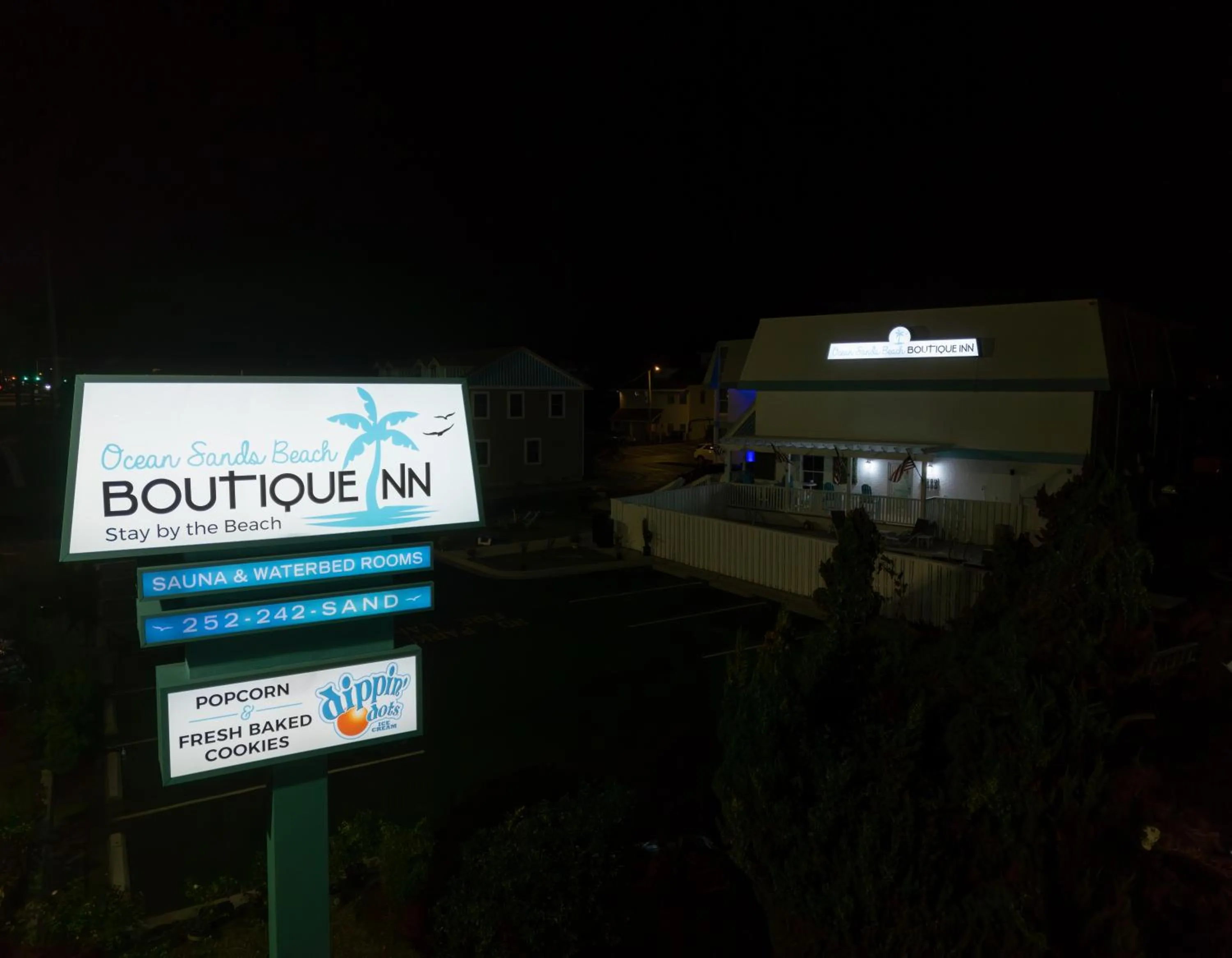 Property building in NEW 2026-Ocean Sands Beach Boutique Inn-Sauna and Salt-Mineral Pool -Free Beach Bikes and Famous Beach- Fresh Baked Cookies and Popcorn - Bathrobes and Sunscreen in all rooms-Ultra Sparkling-Free Laundry- 4 Grand Black Beds-Call NOW & Save-1-252-AHA-SAND