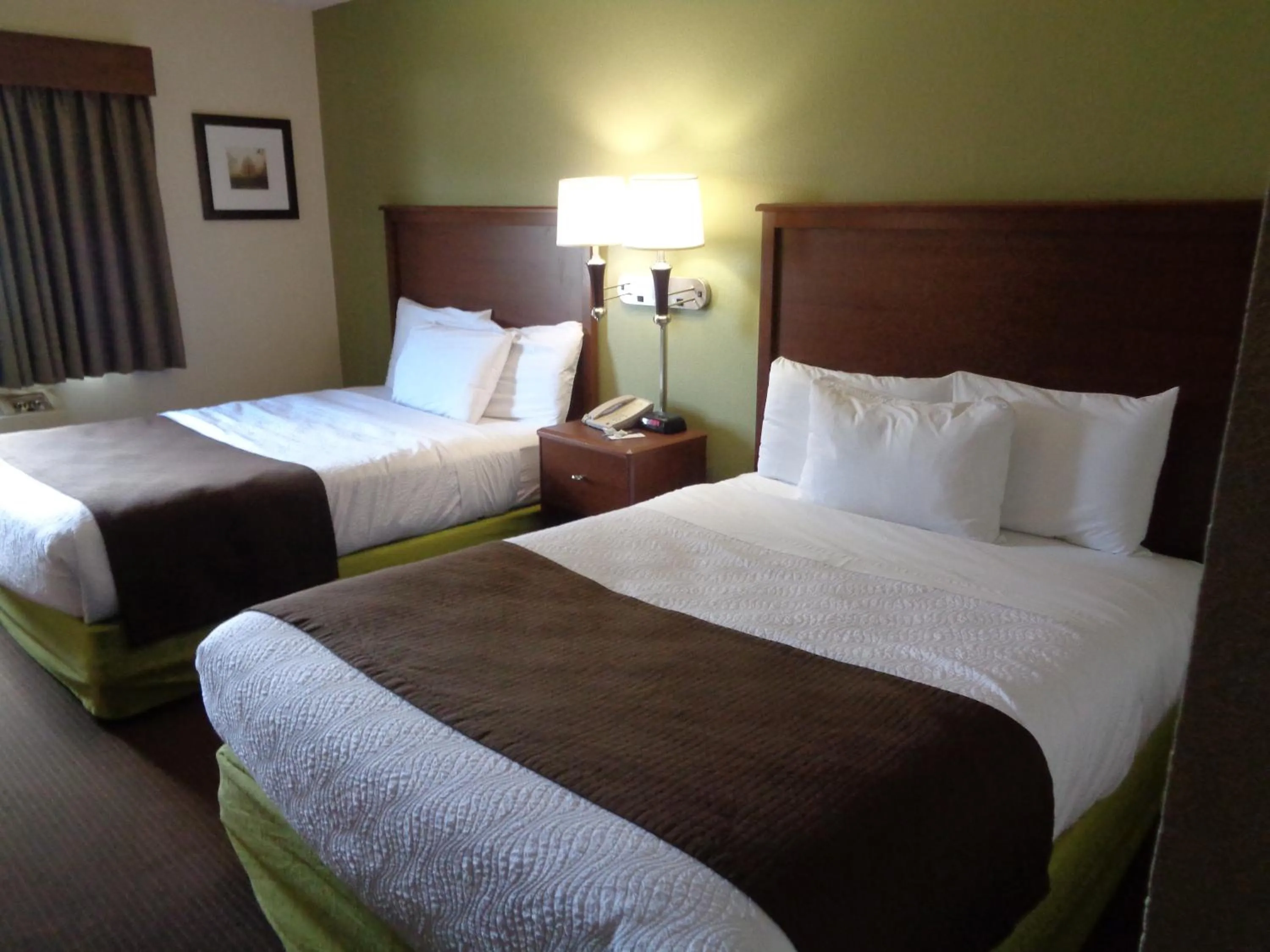Bedroom in AmericInn by Wyndham Grand Rapids