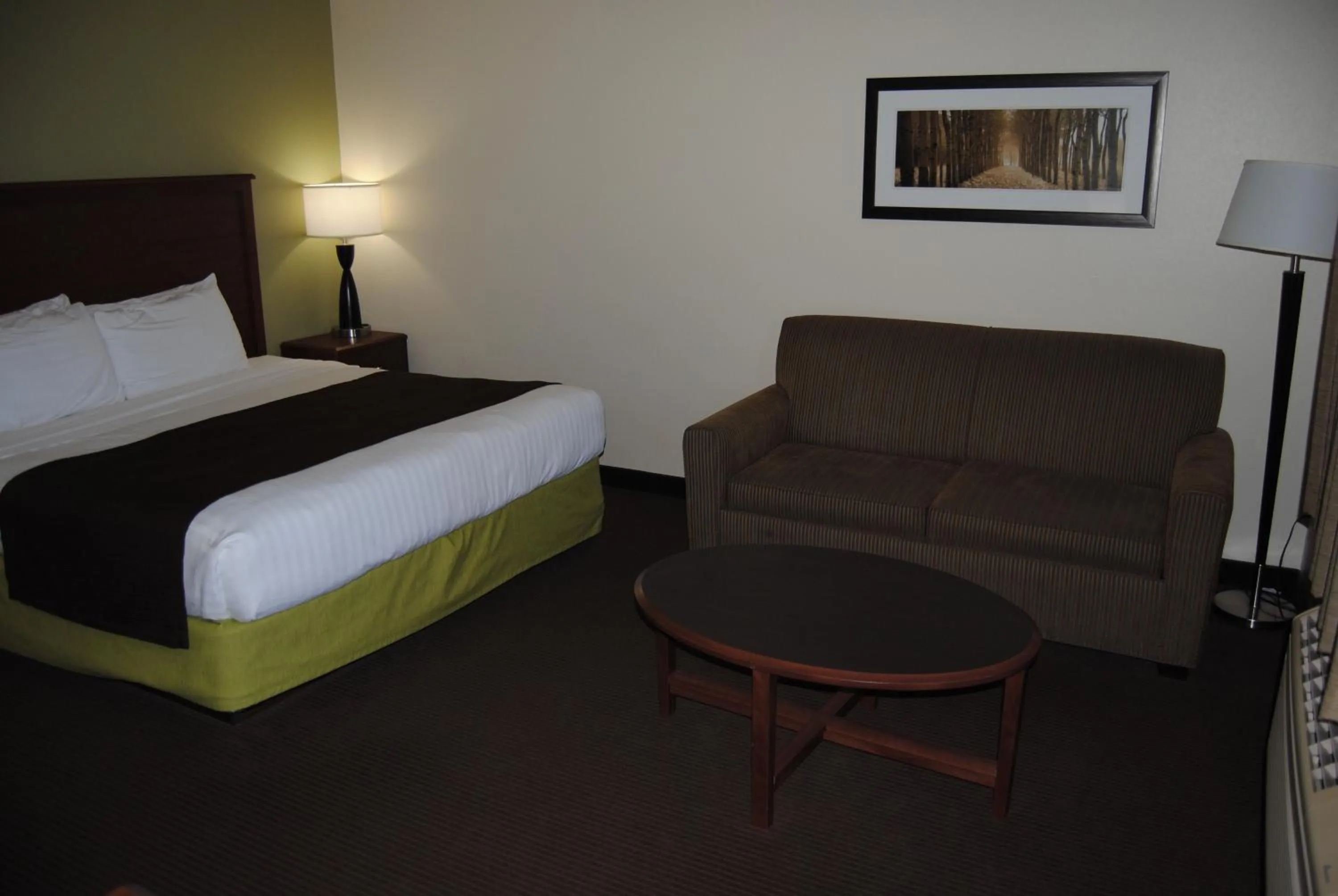 Bed in AmericInn by Wyndham Grand Rapids