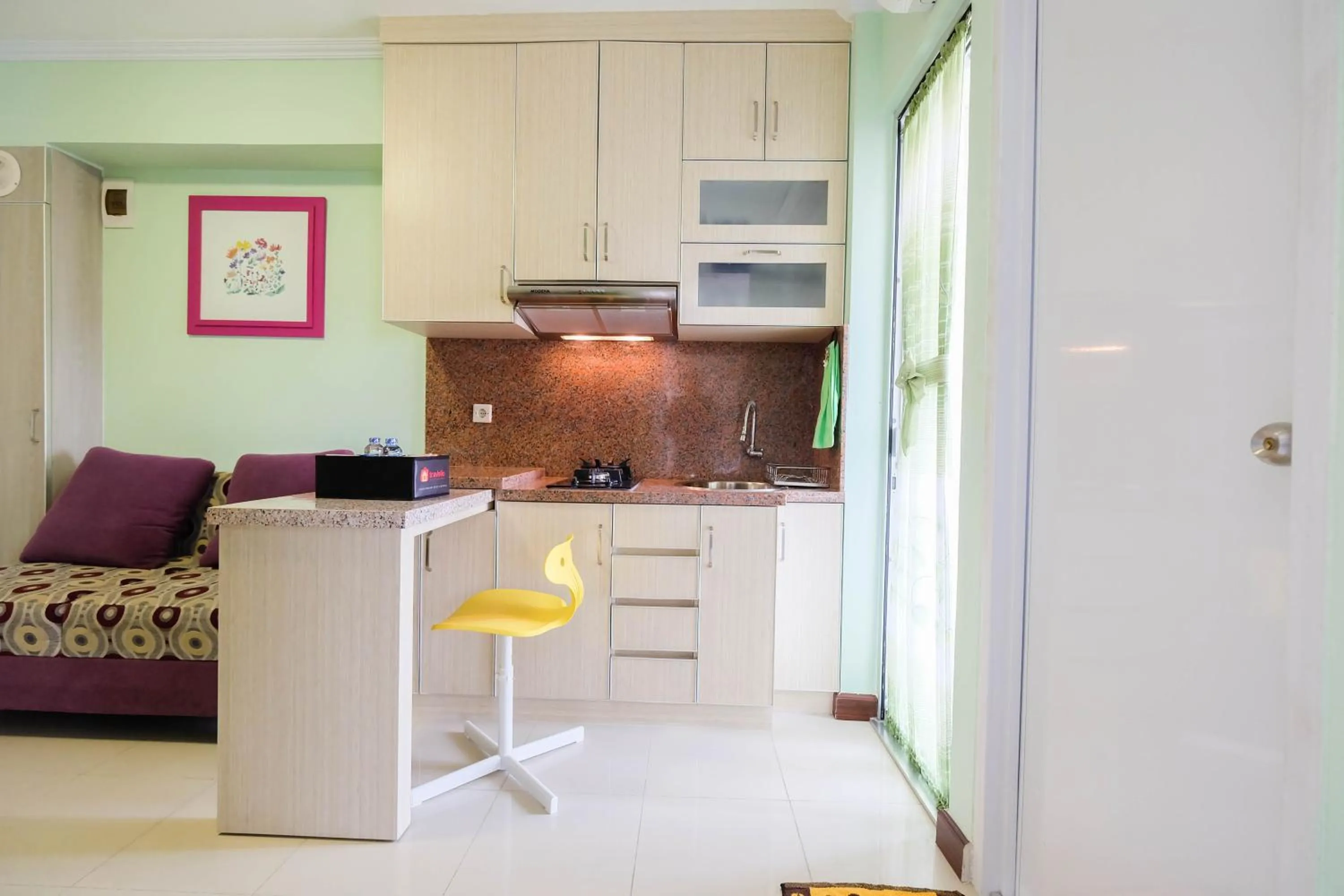 Kitchen or kitchenette in Cozy 2BR Bassura City Apartment By Travelio