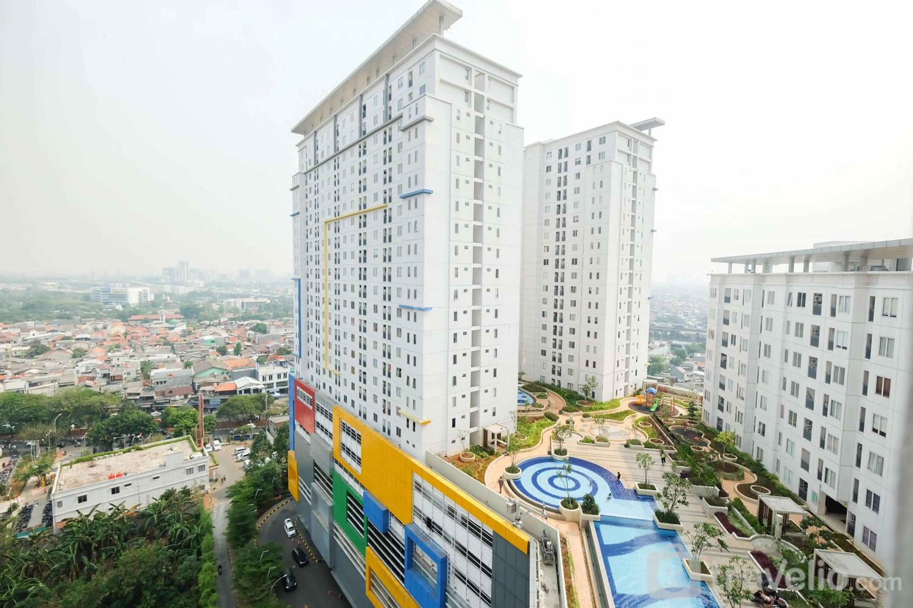 Property building in Cozy 2BR Bassura City Apartment By Travelio