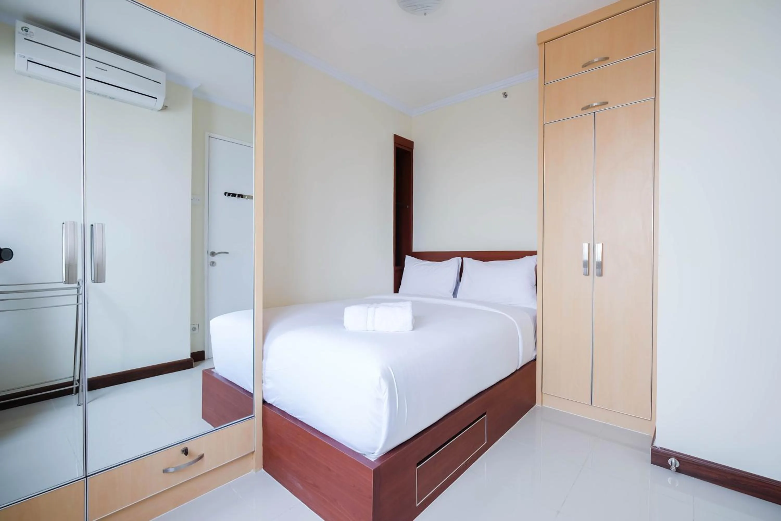 Bed in Cozy 2BR Bassura City Apartment By Travelio