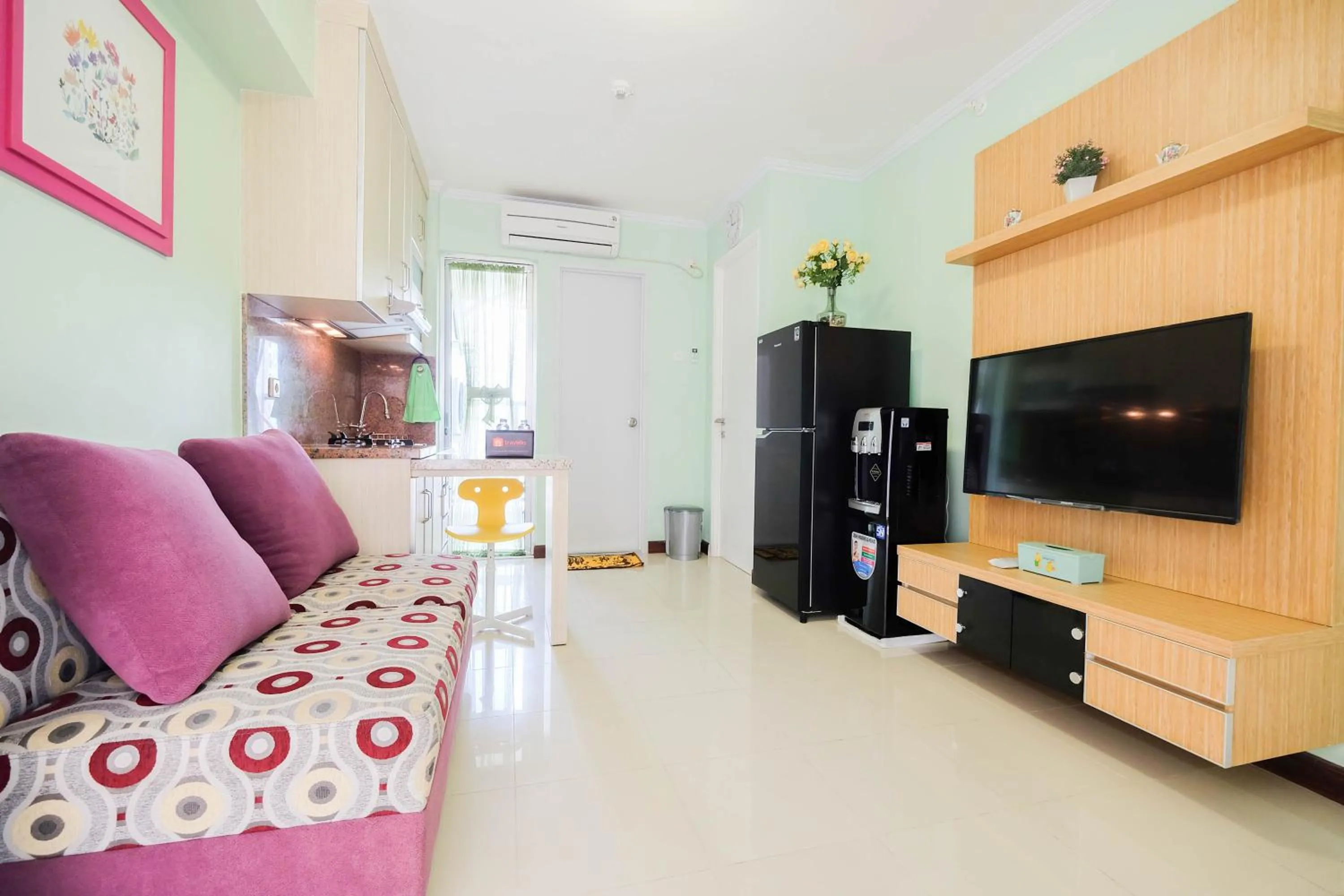 Living room in Cozy 2BR Bassura City Apartment By Travelio