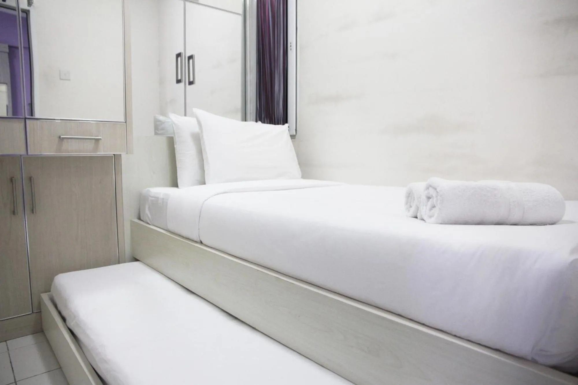 Bed in Comfortable 2BR Mutiara Bekasi Apartment By Travelio