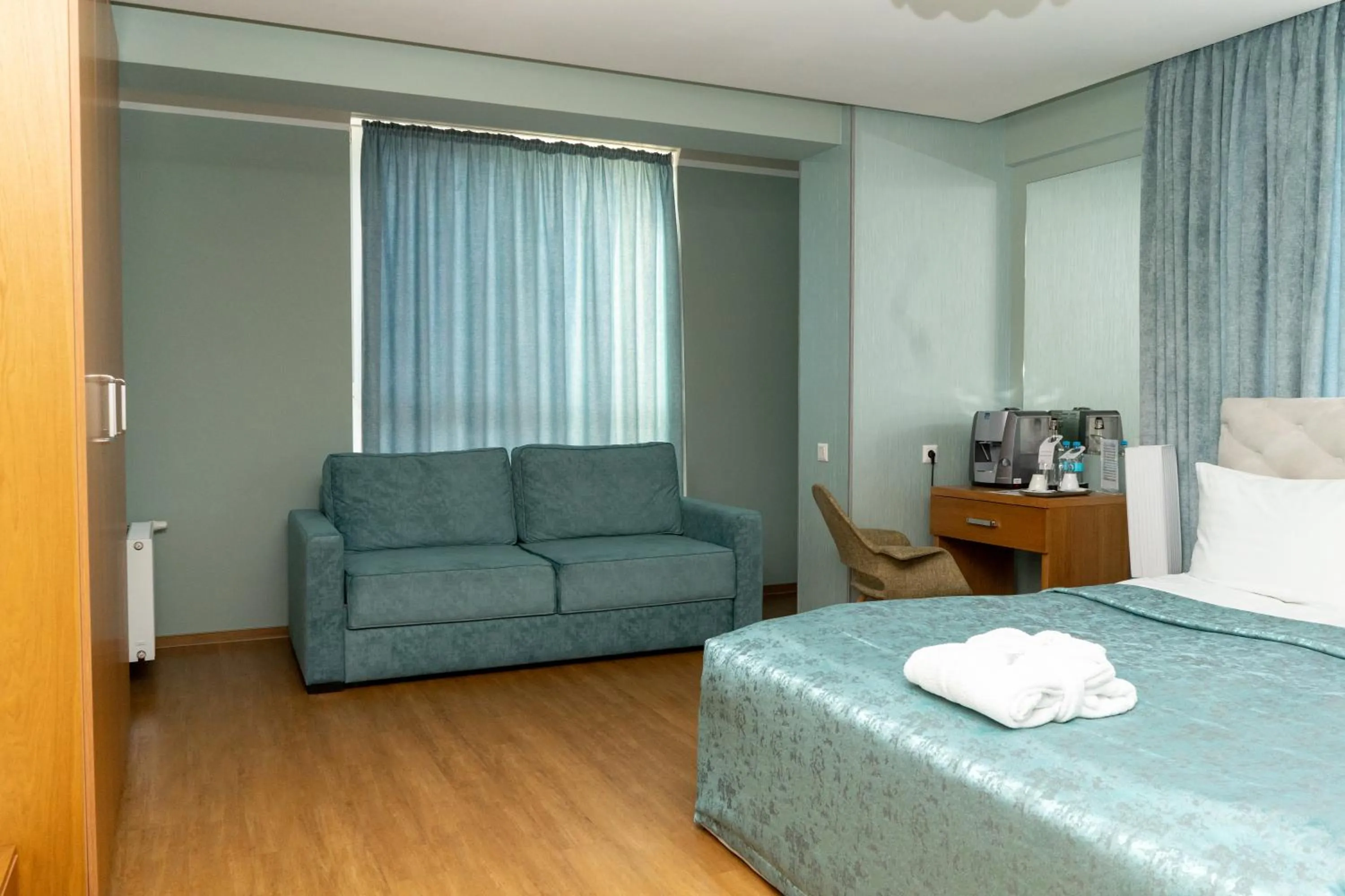 Communal lounge/ TV room, Bed in Light Hotel