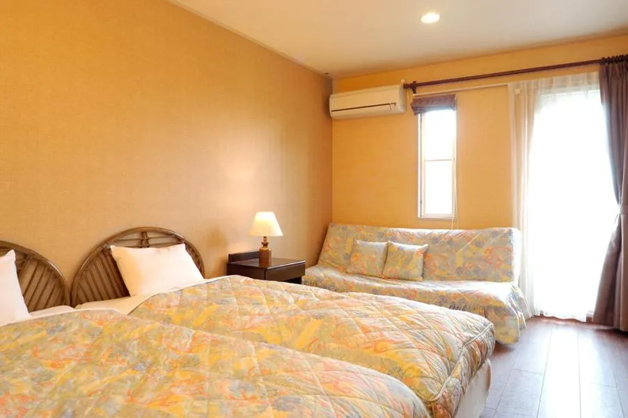 Bed in Petit Resort Hotel Alcyon