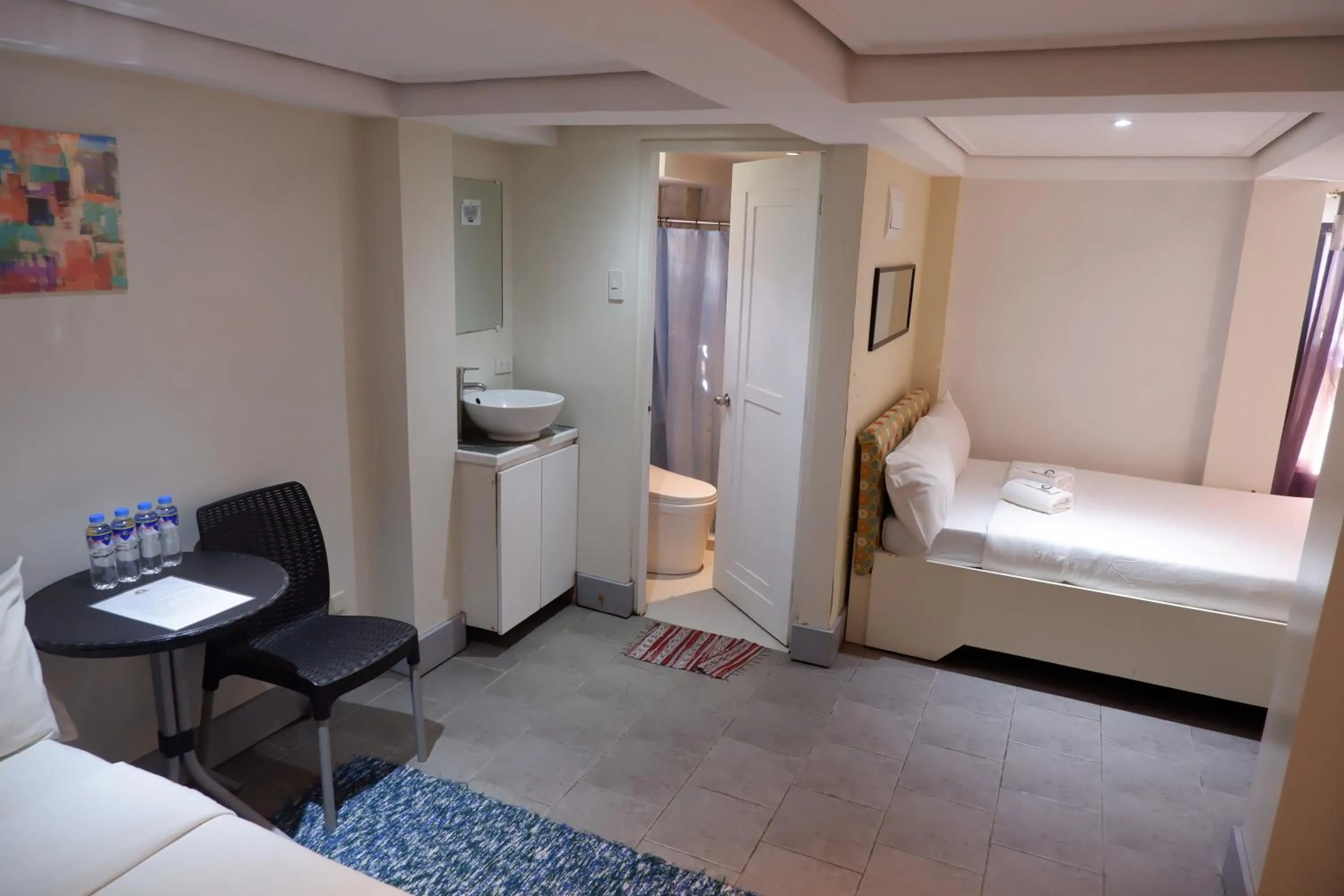 Toilet, Bed in Sunset View Ridge Residences