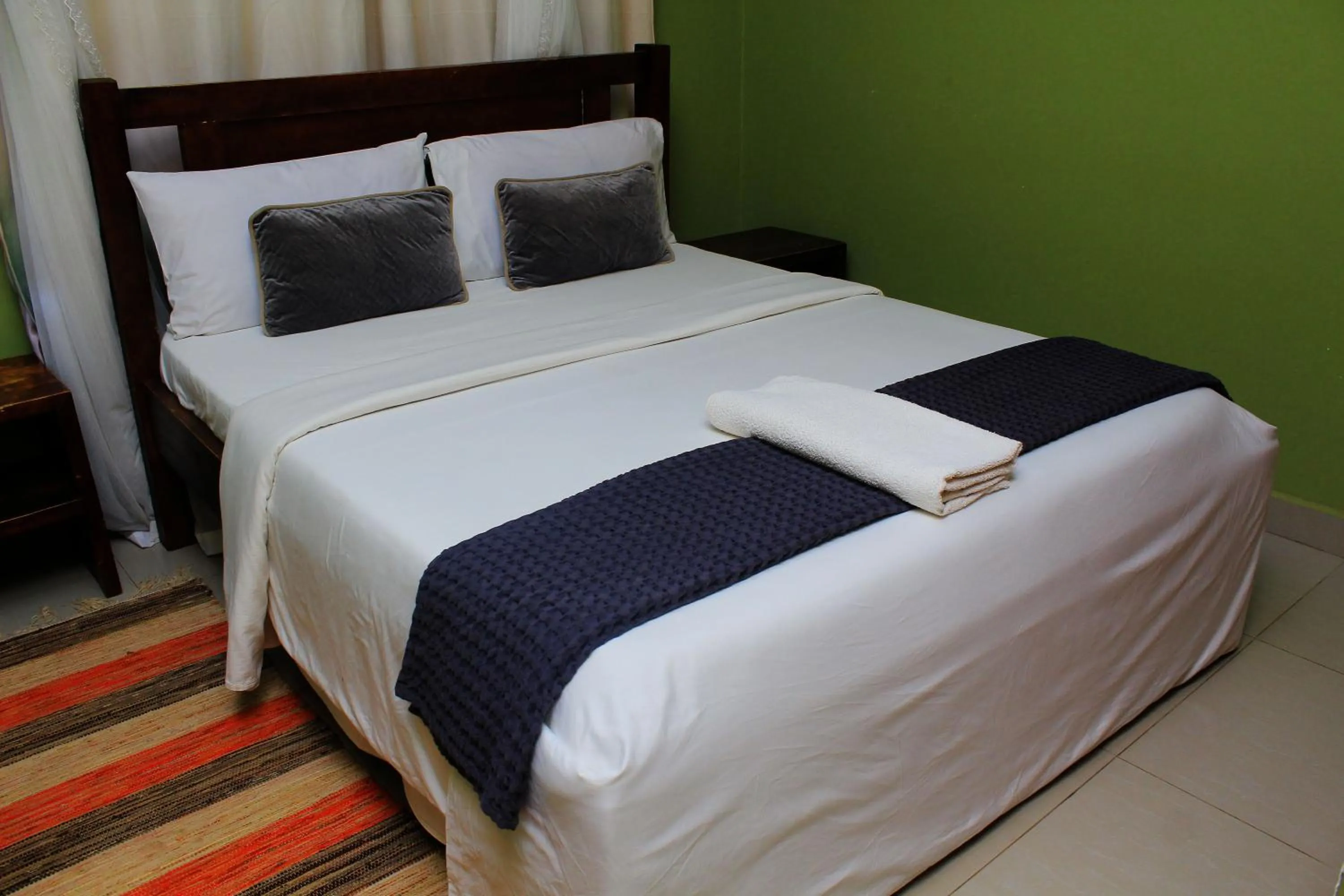 Bed in MAMIKKI Hotel Apartments