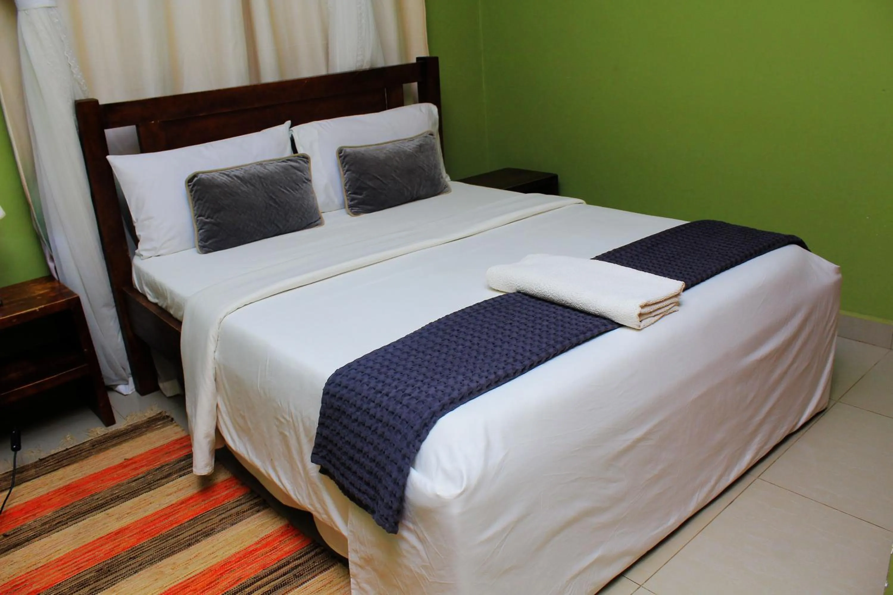 Bed in MAMIKKI Hotel Apartments