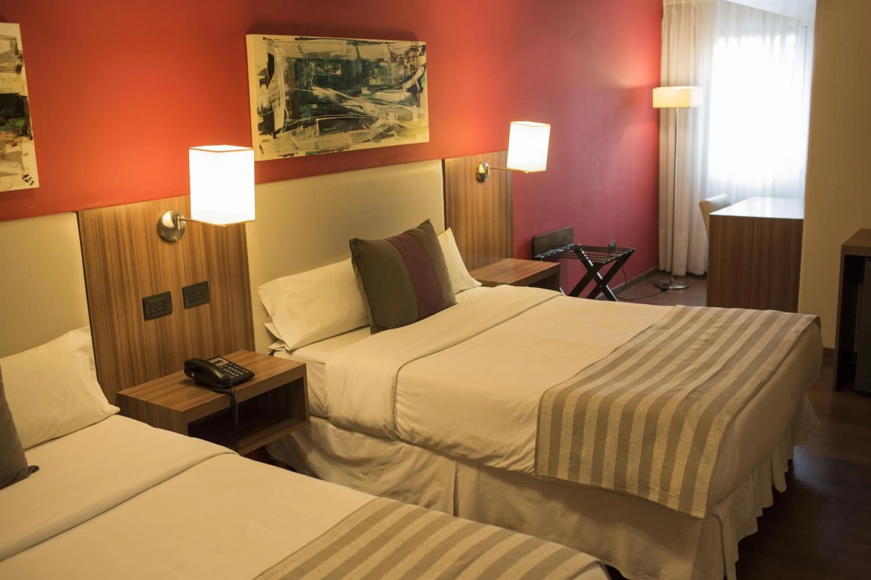 Bed in Hotel Bicentenario Suites & Spa