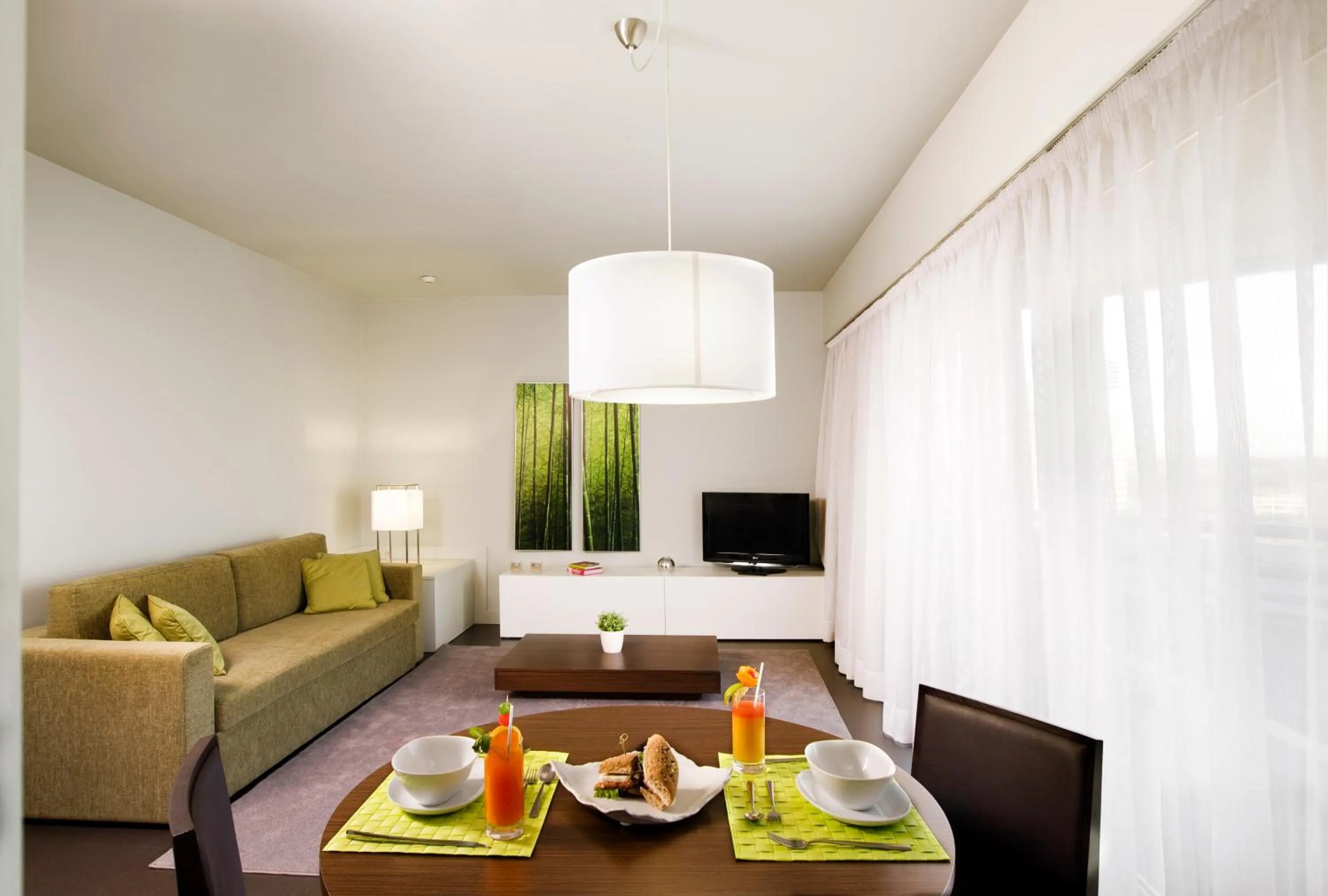 Communal lounge/ TV room in Aqualuz Troia Rio by The Editory