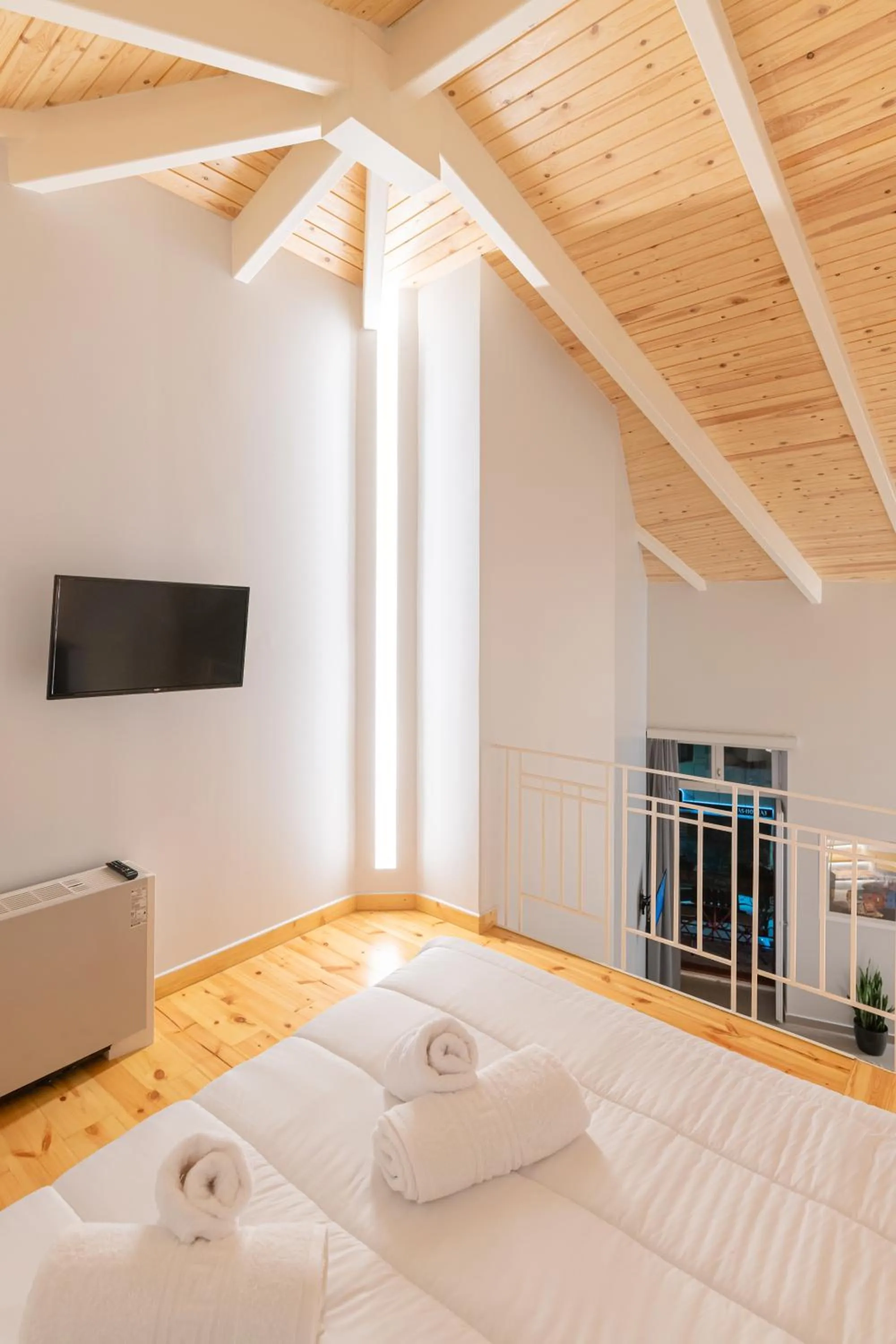 Bed in Ether Loft Suites