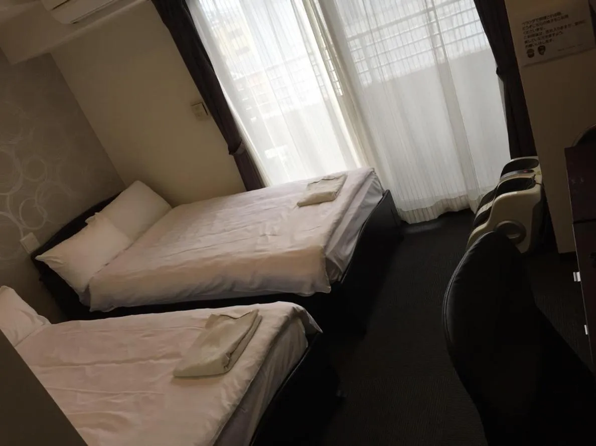 Bed in Omura Station Hotel