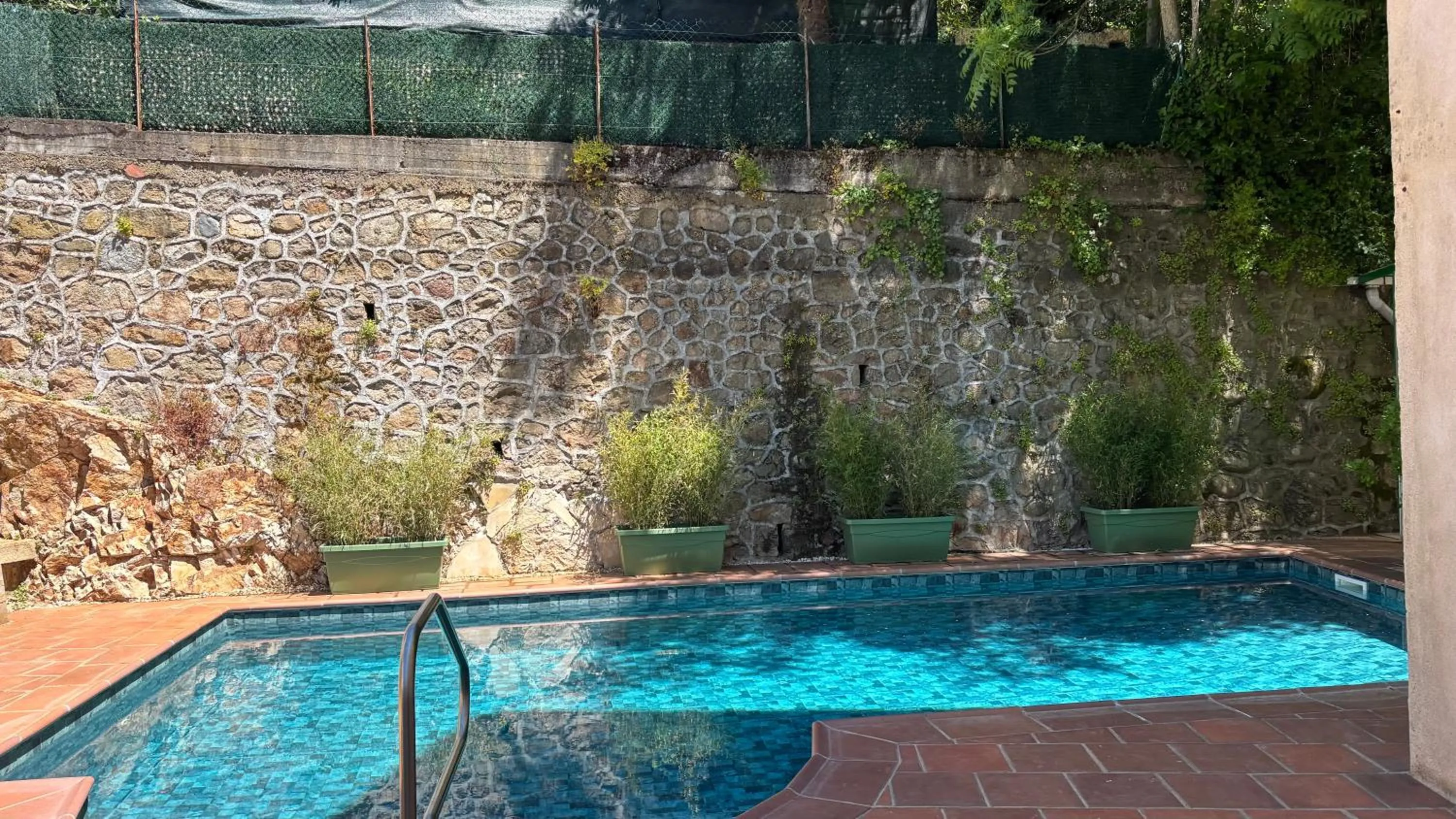 Swimming pool in Logis Hôtel Restaurant Grand Hôtel de Lyon