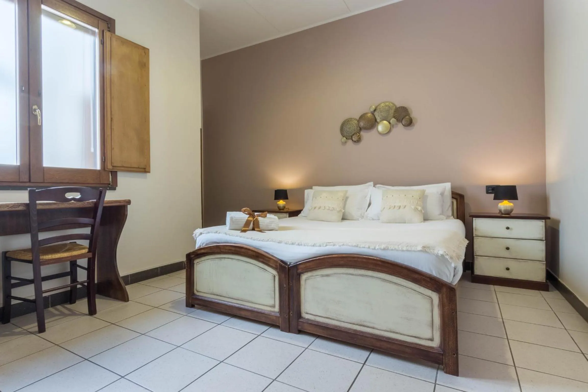 Bed in Arcobaleno Rooms