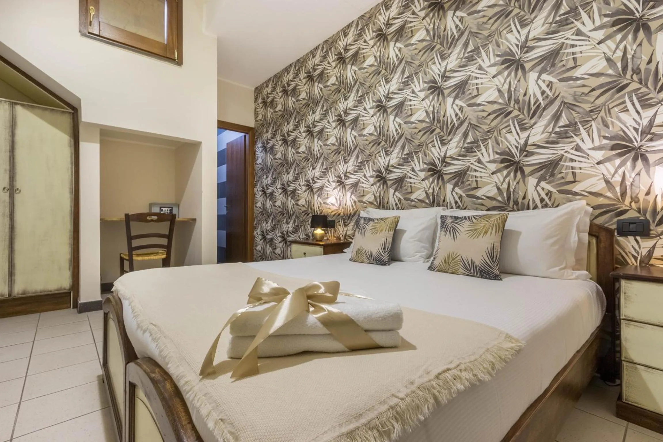 Bed in Arcobaleno Rooms