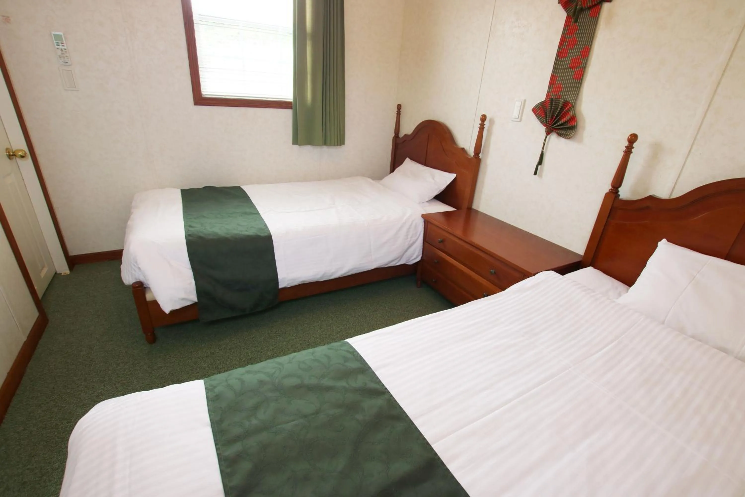 Bed in cottage NORTH OKINAWA -SEVEN HOTELS & Resorts-