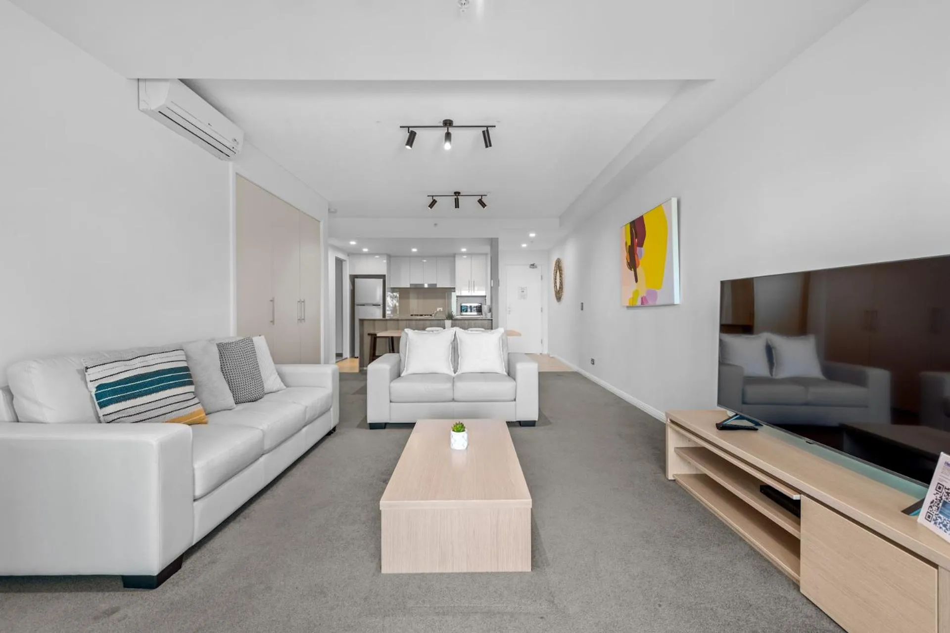 Living room, Bed in Proximity Waterfront Apartments