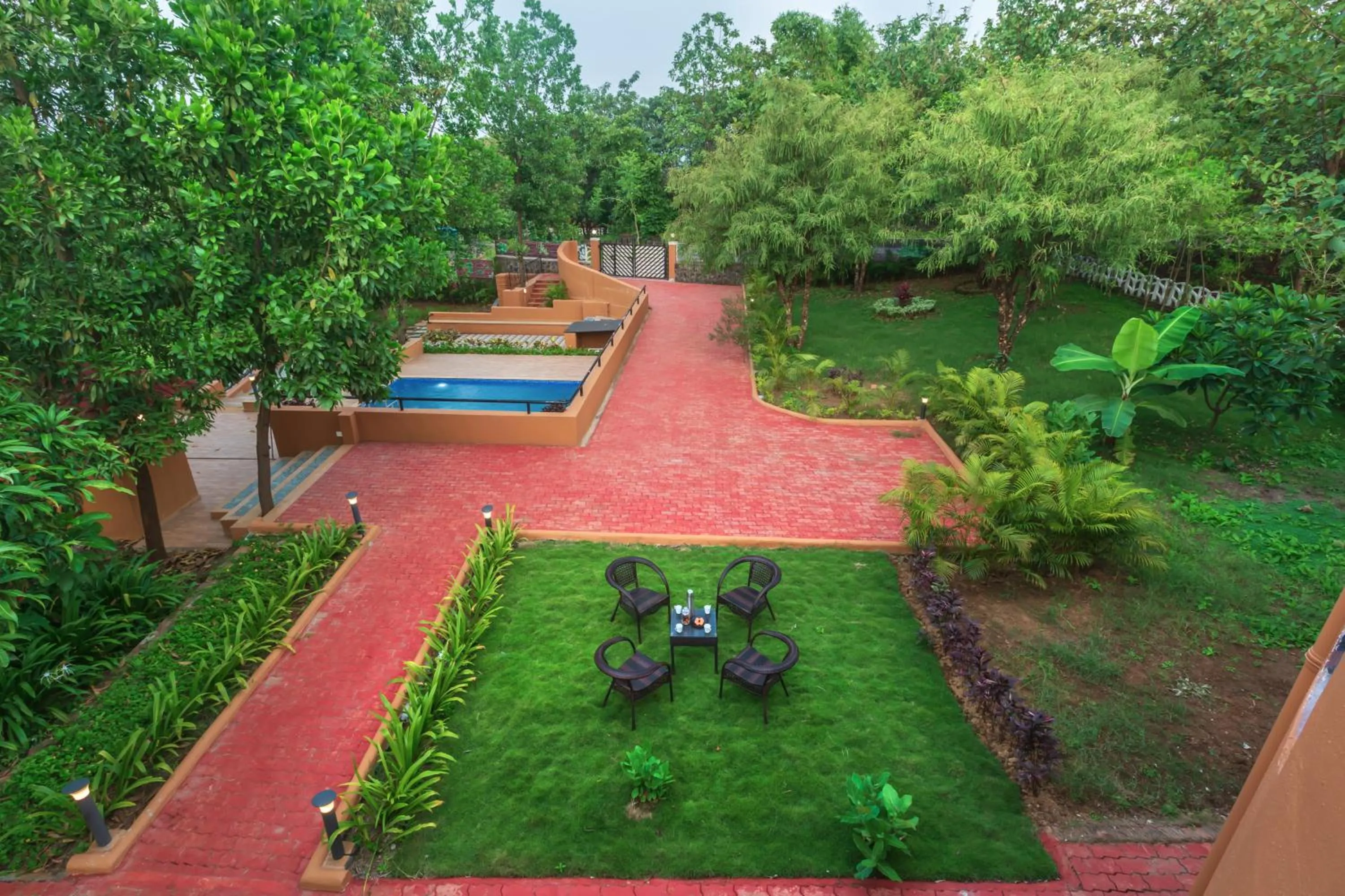 Day in SaffronStays Ekaant- 3BR pet-friendly pool villa with lawn, games & river walk in gated community near Mumbai