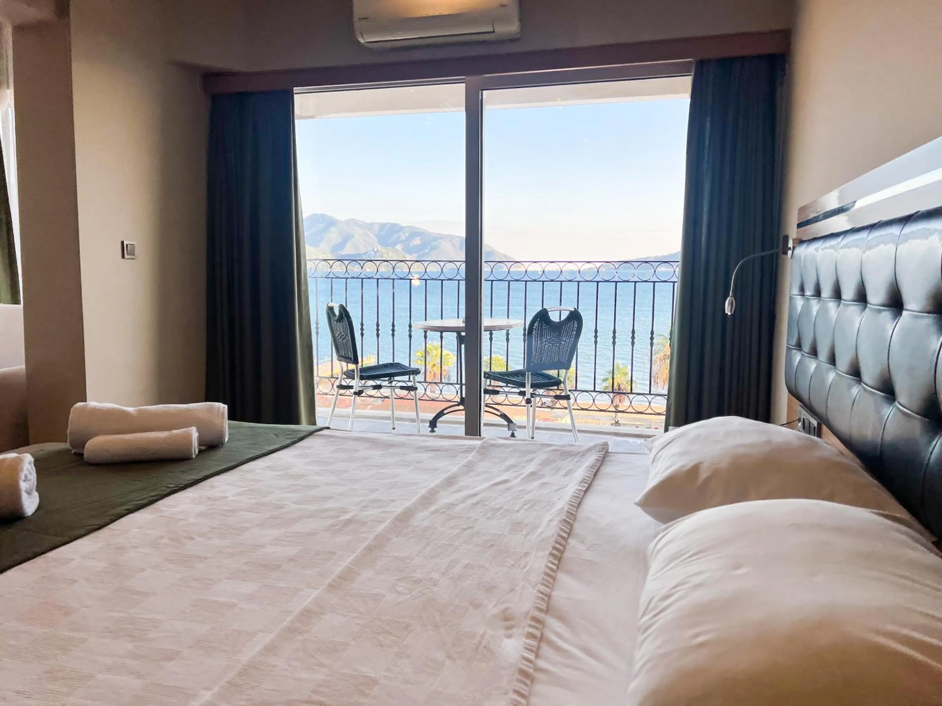 Bed in Aurasia Sea Side Hotel