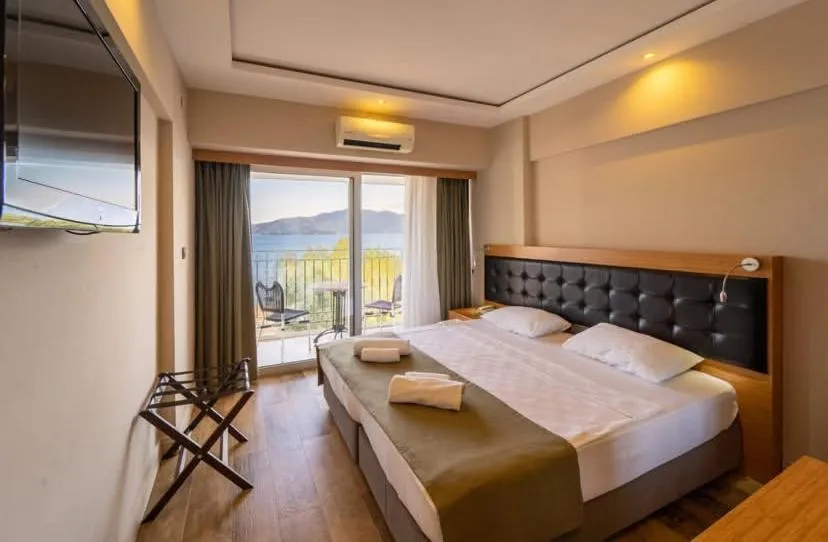 Bed in Aurasia Sea Side Hotel