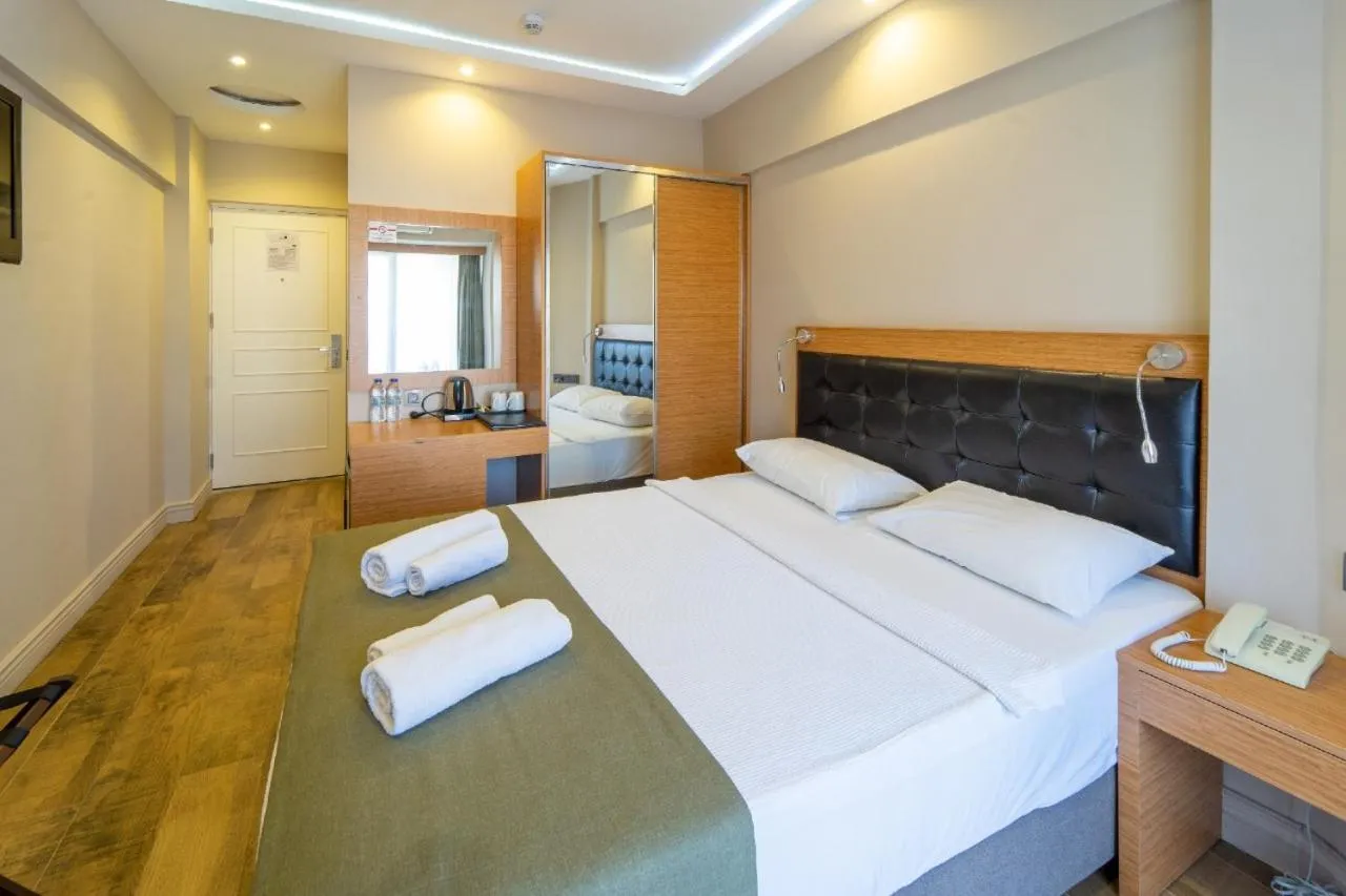 Bed in Aurasia Sea Side Hotel