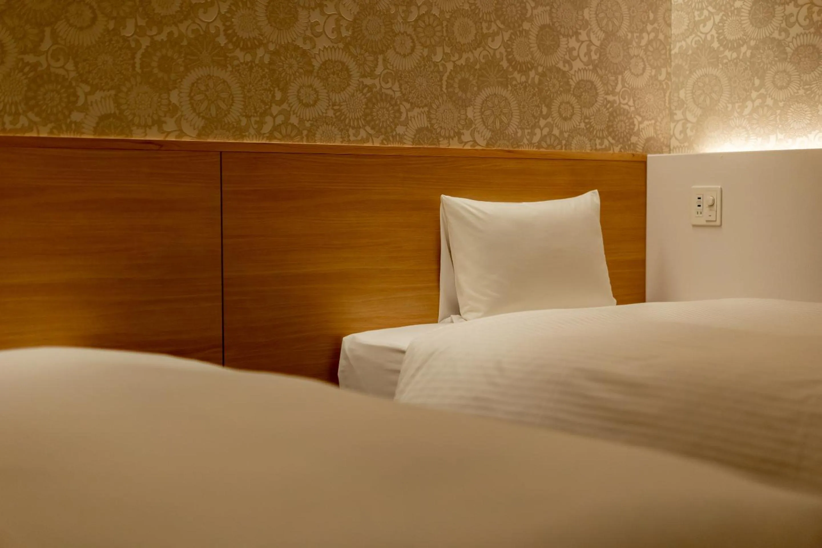 Bed in RESI STAY Hachi Inn