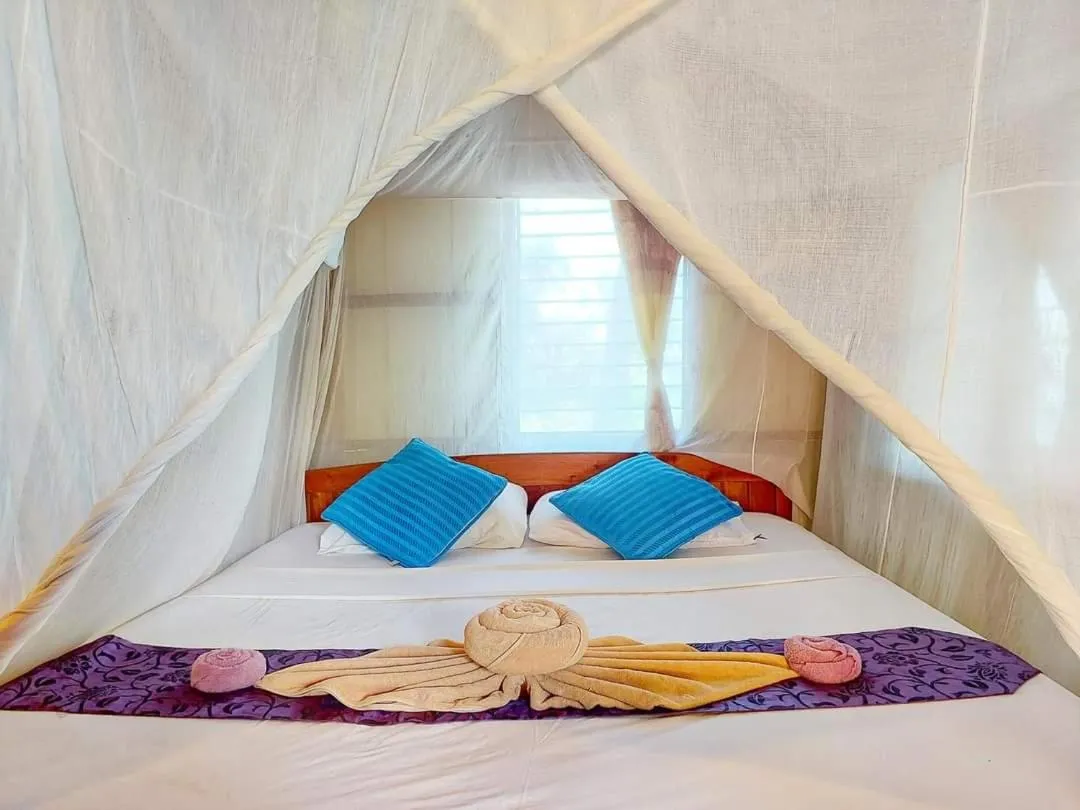 Bed in Jungle Hill Beach Bungalow