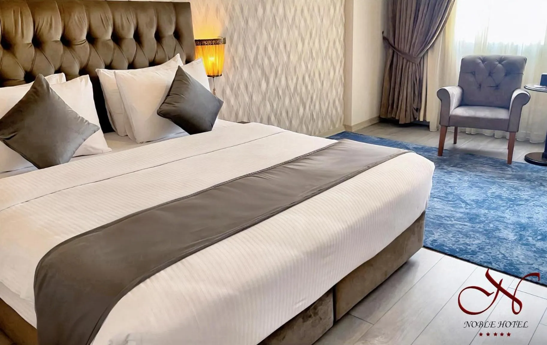 Living room, Bed in Noble Hotel