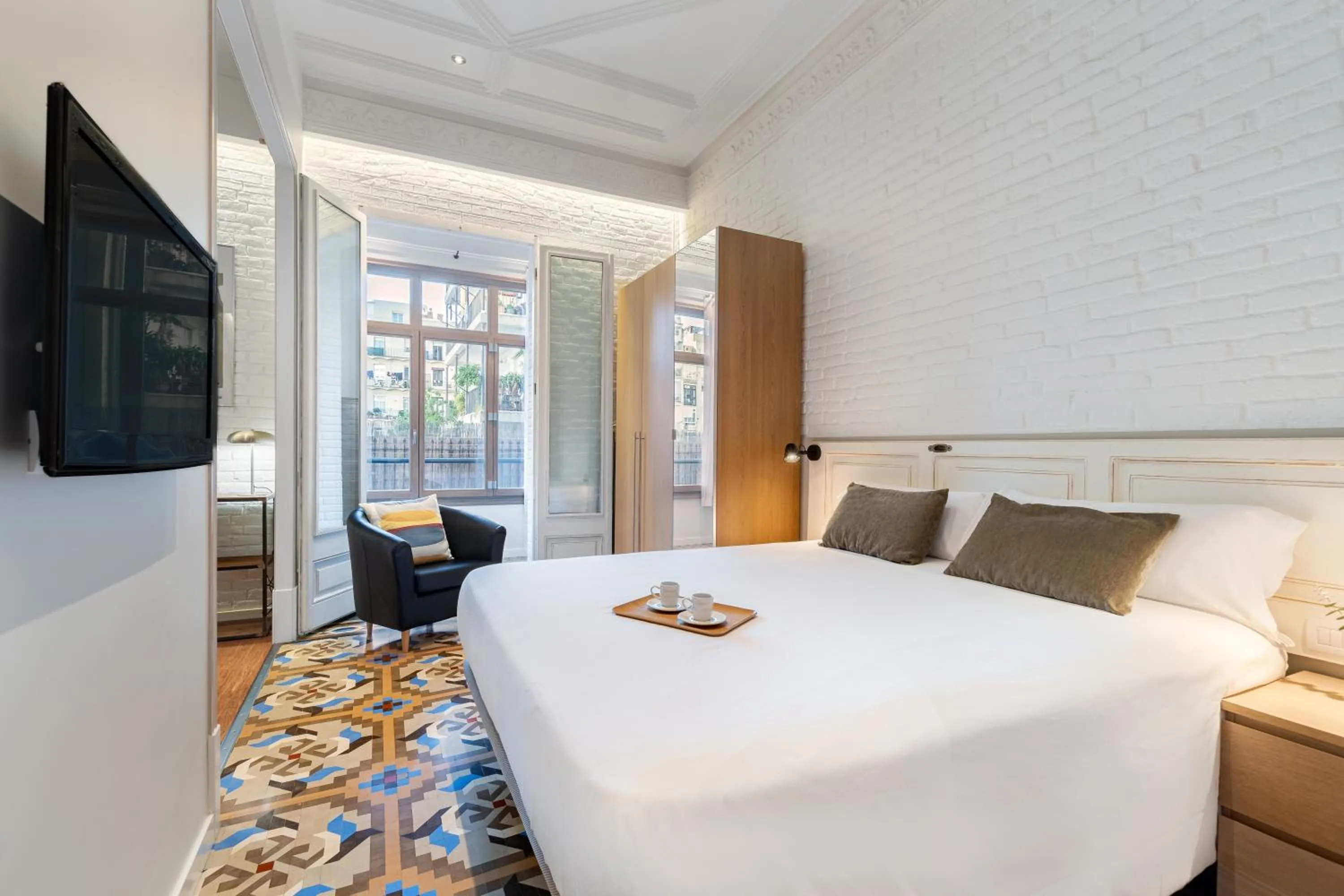 Bed in Fuster Apartments by Aspasios