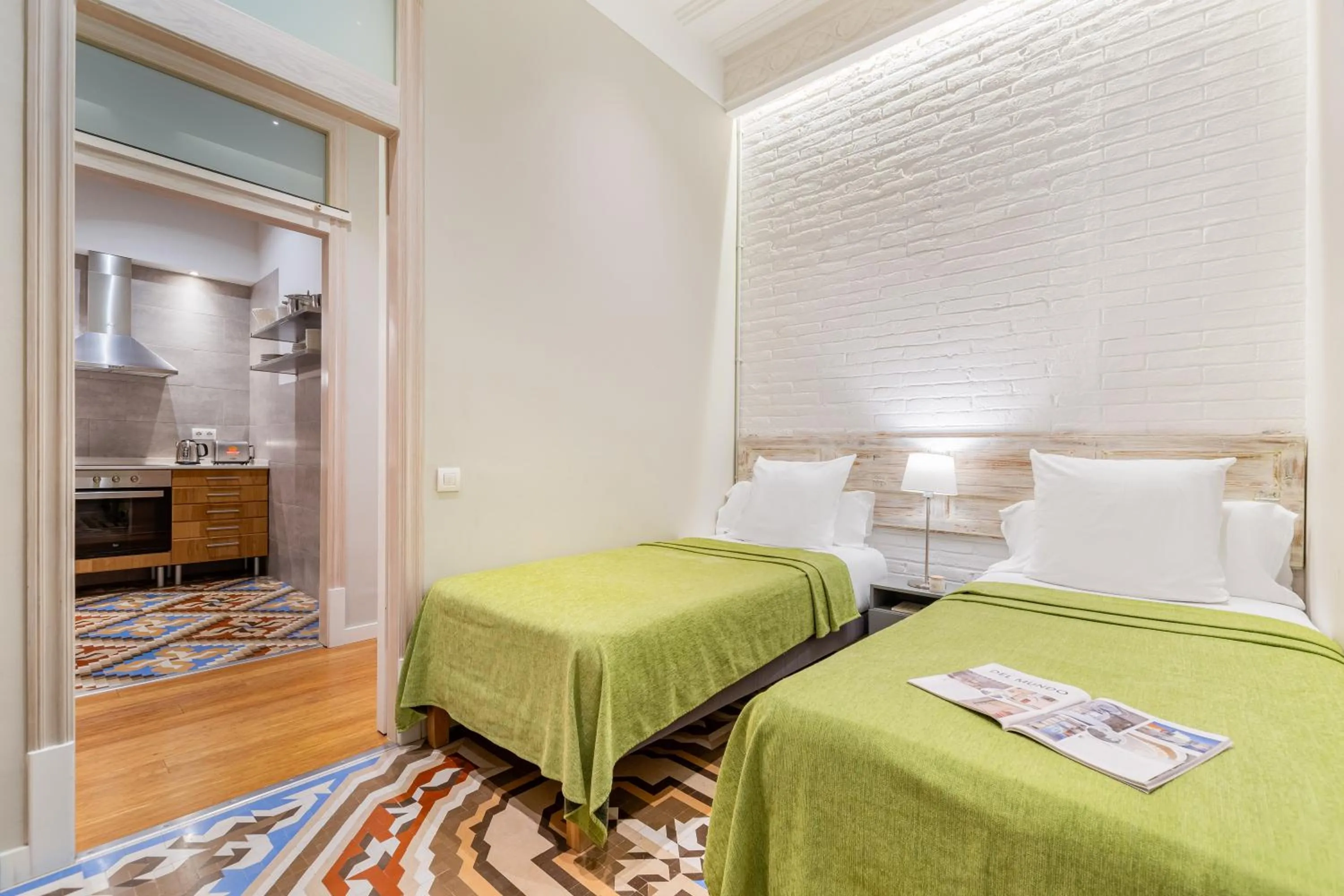 Bed in Fuster Apartments by Aspasios