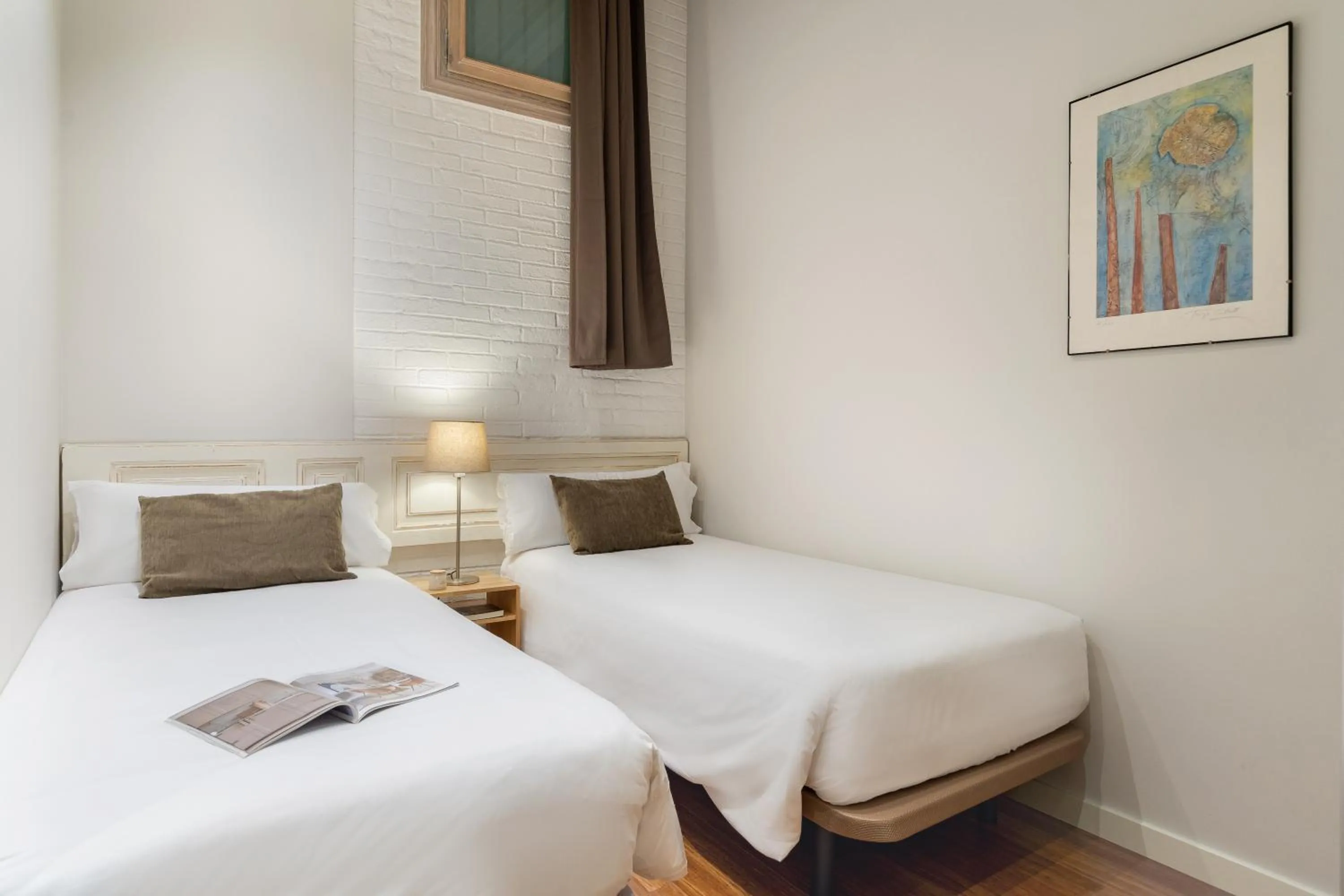 Bed in Fuster Apartments by Aspasios